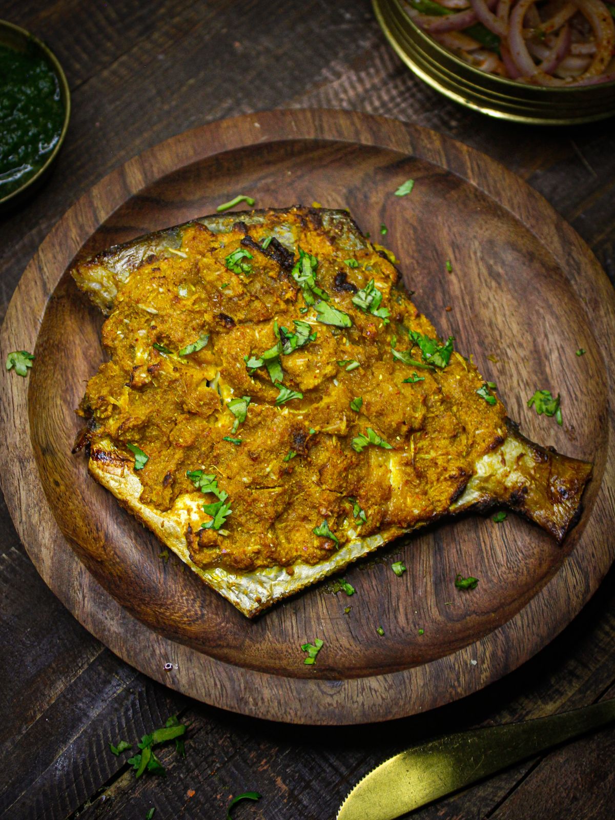 Once it is cooked properly, transfer the fish into a wooden plate 