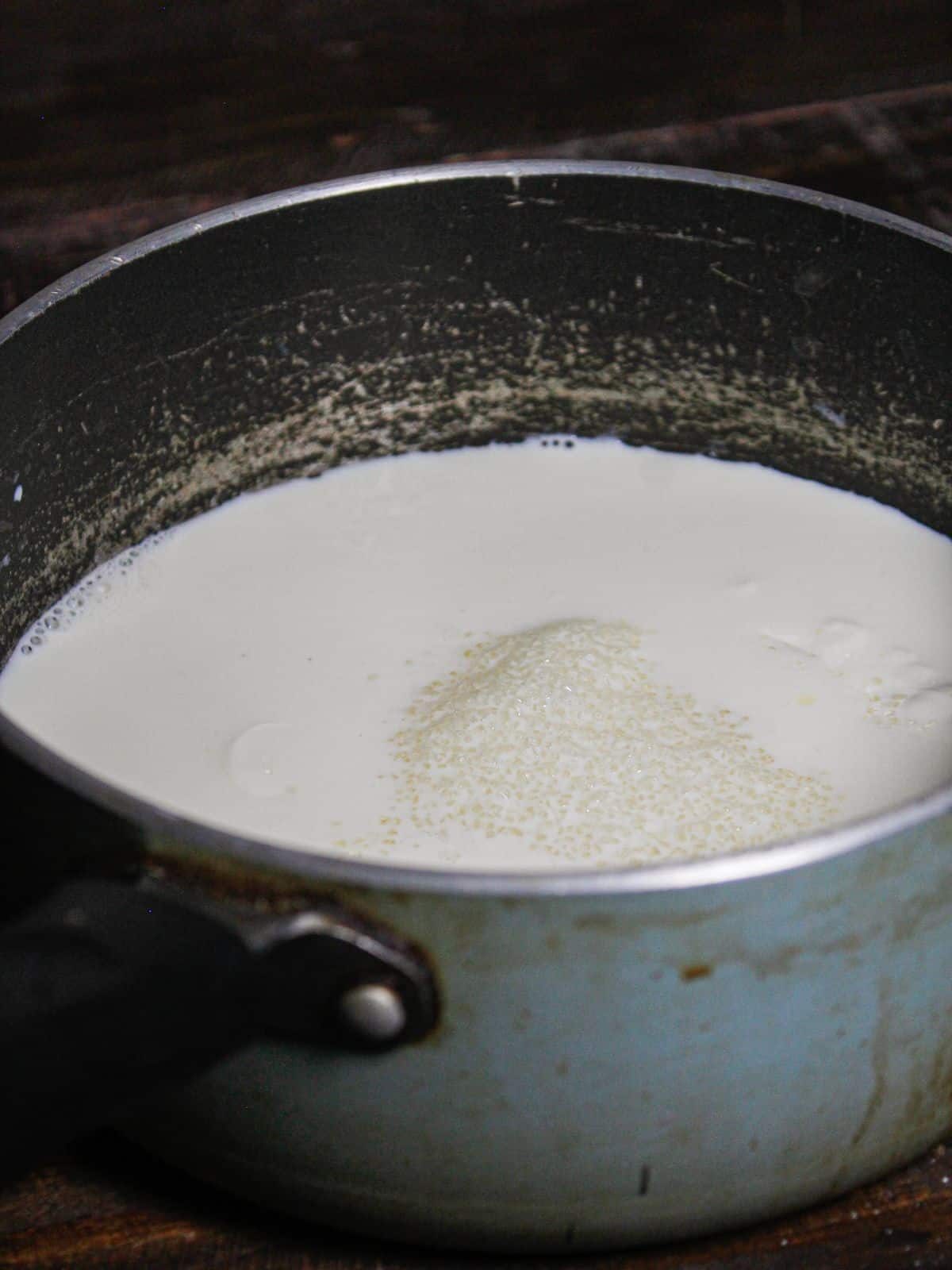 Add sugar to the milk in the vessel 