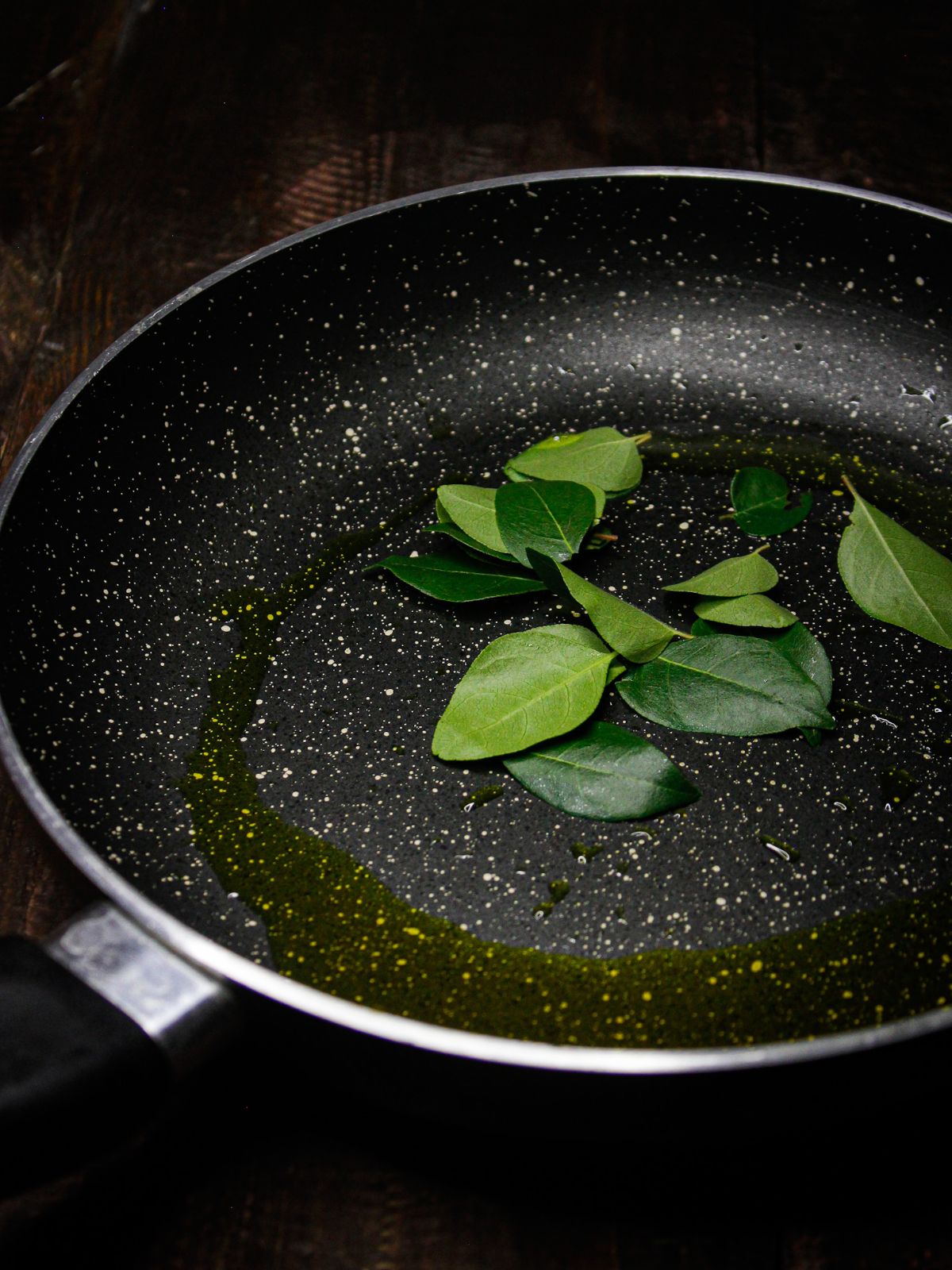 Take oil and curry leaves in a pan and let them crackle 