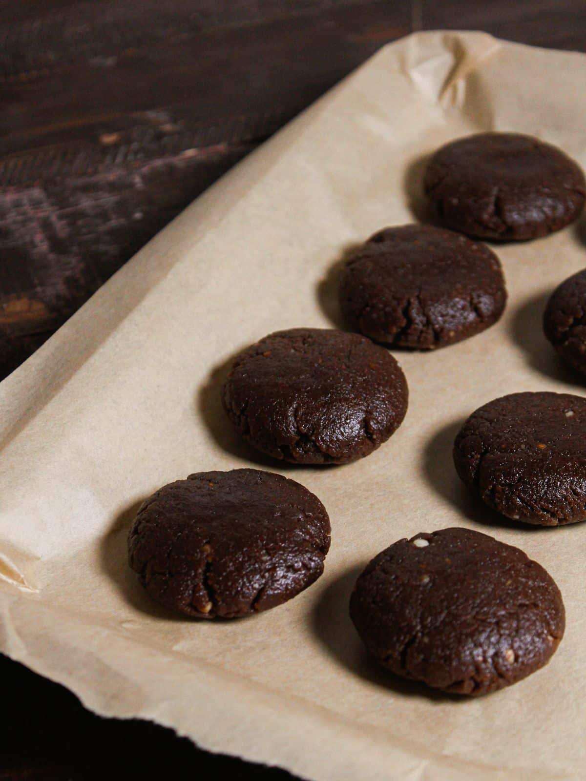 Make small small disc shaped balls from dough and line up in baking tray 