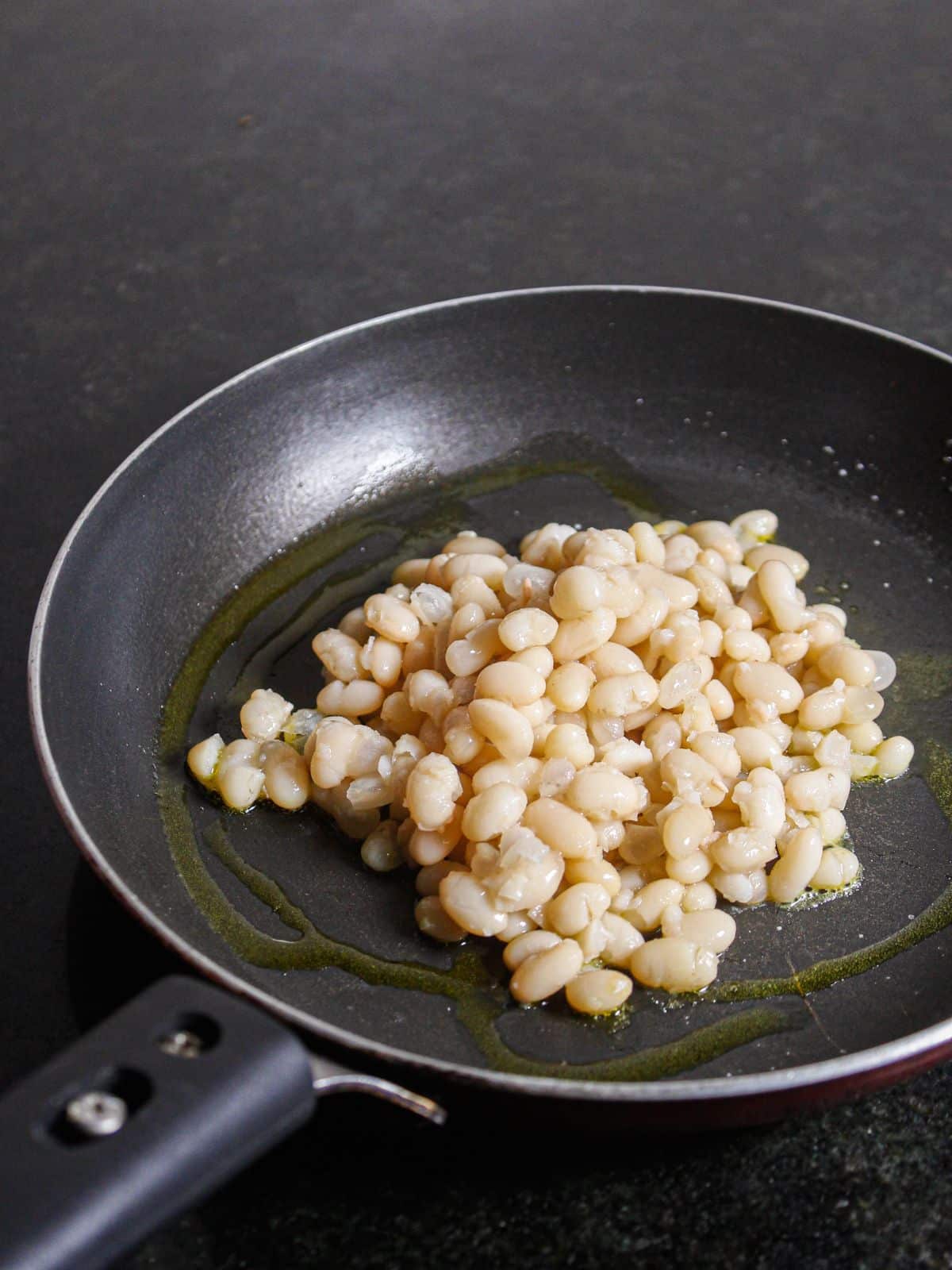 Add boiled soyabeans and oil in a pan 