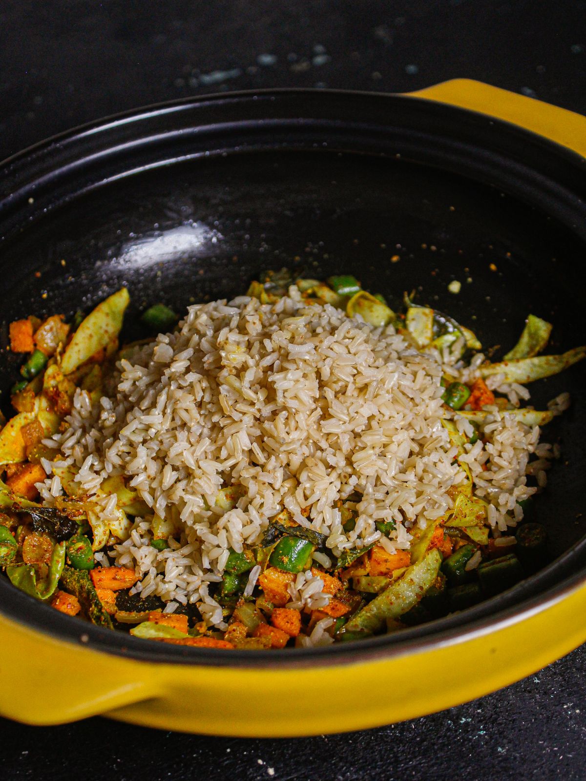 Add cooked brown rice to the pan and mix well 