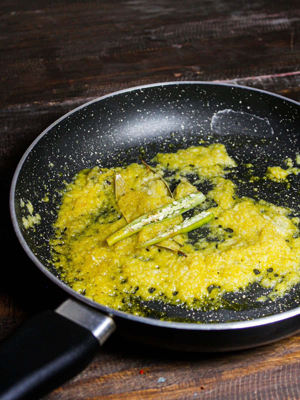 Add slit green chilies to the pan and saute 