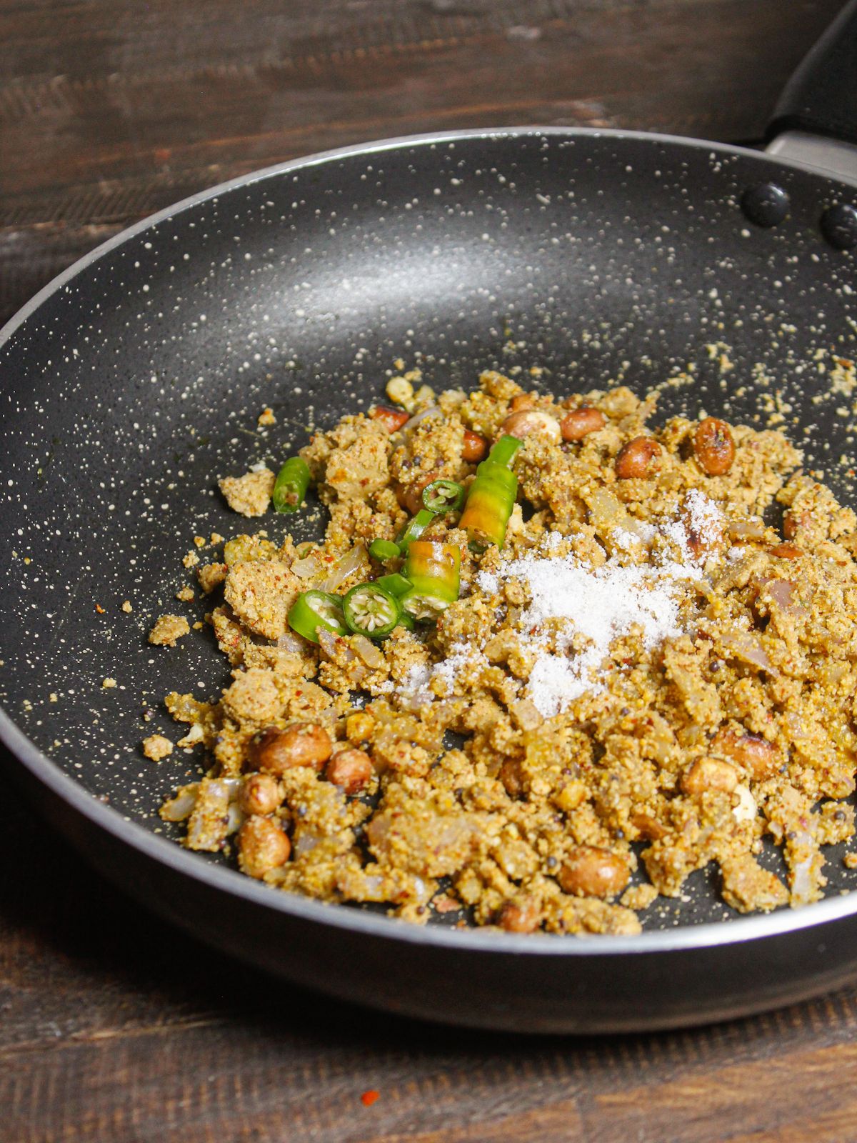 Add chopped green chilies and salt to the pan 