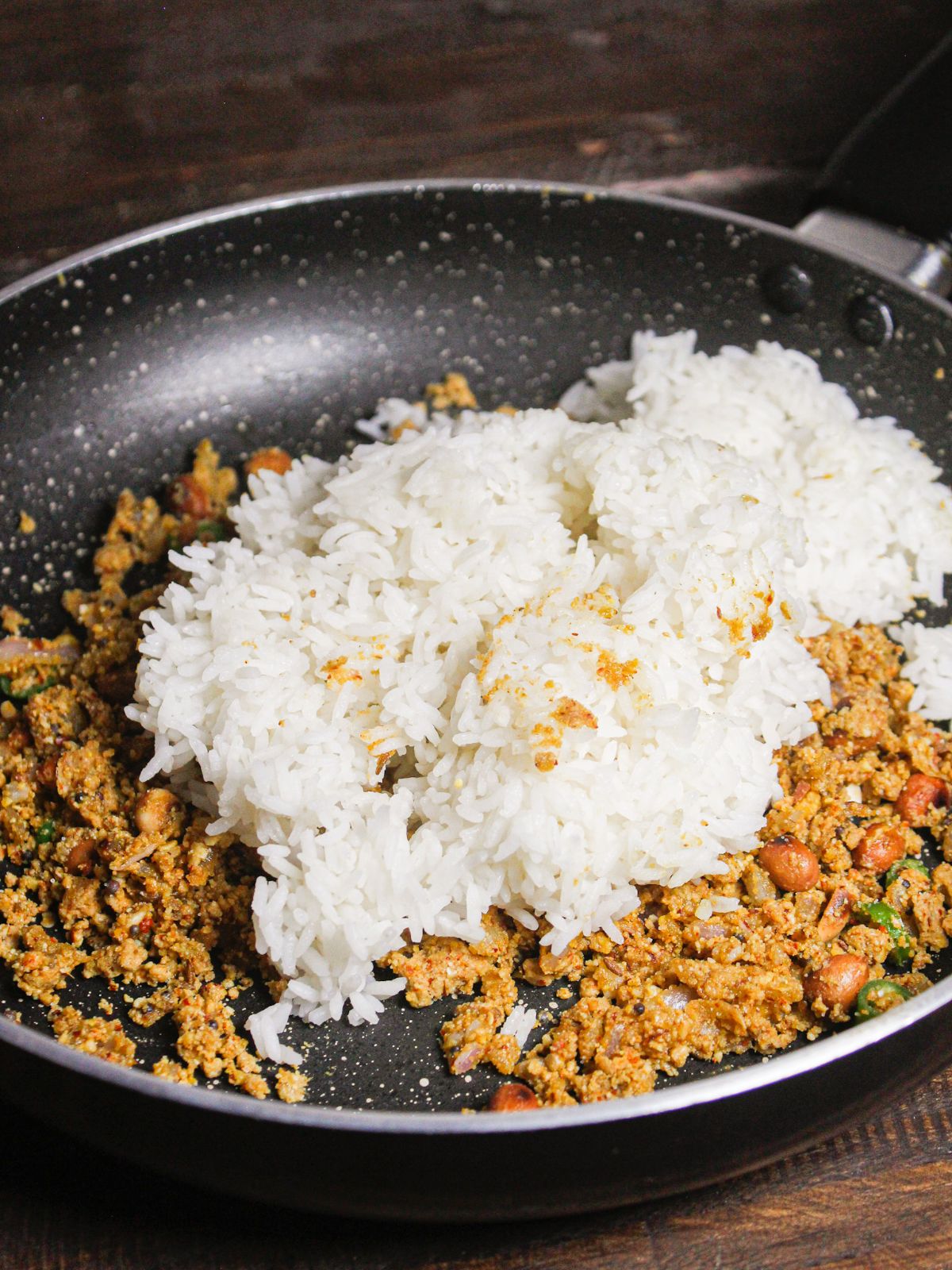 Add boiled rice to the pan and mix well 