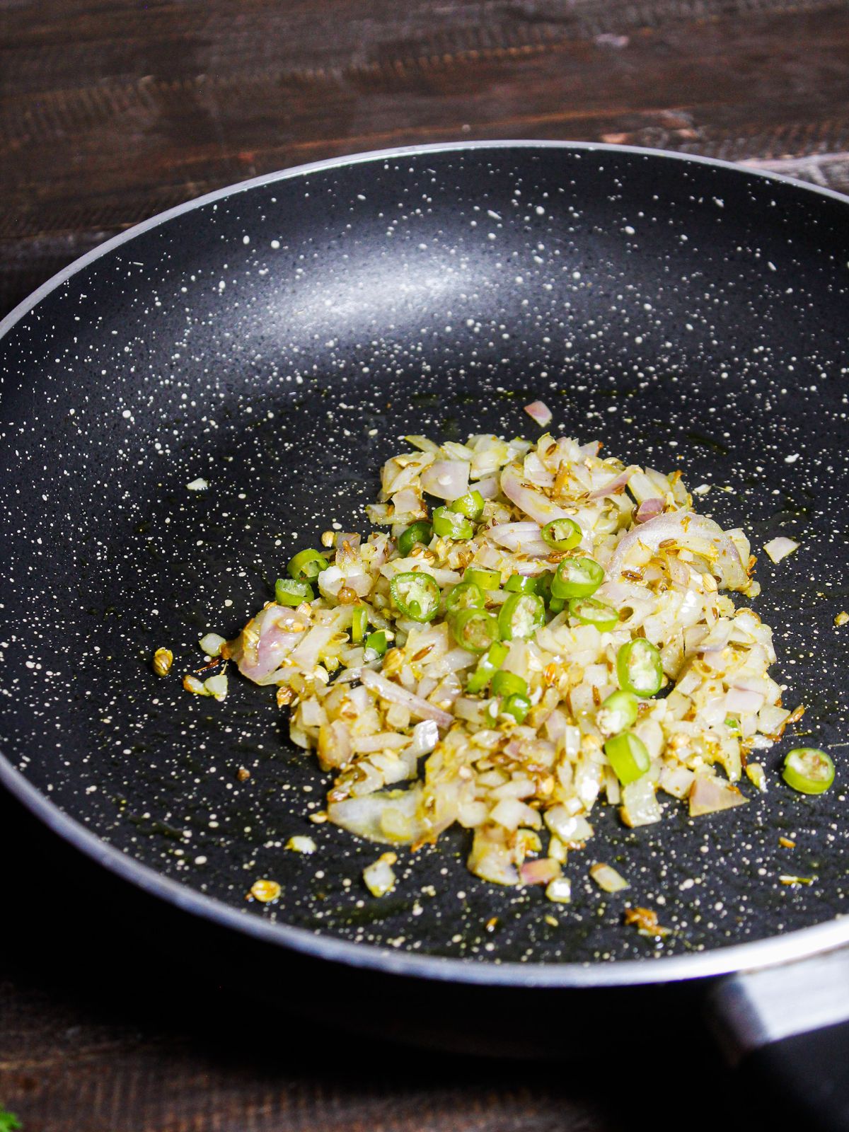 Add chopped green chilies to the pan 