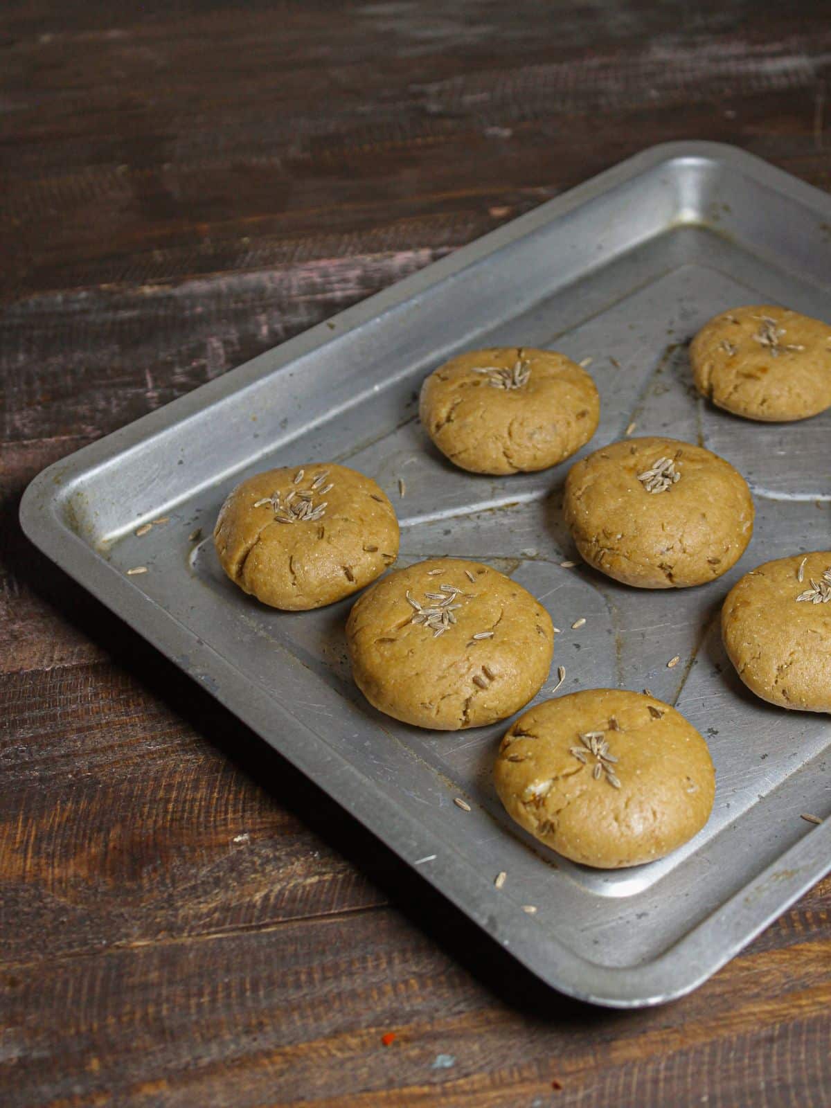 Sprinkle cumin seeds over the discs