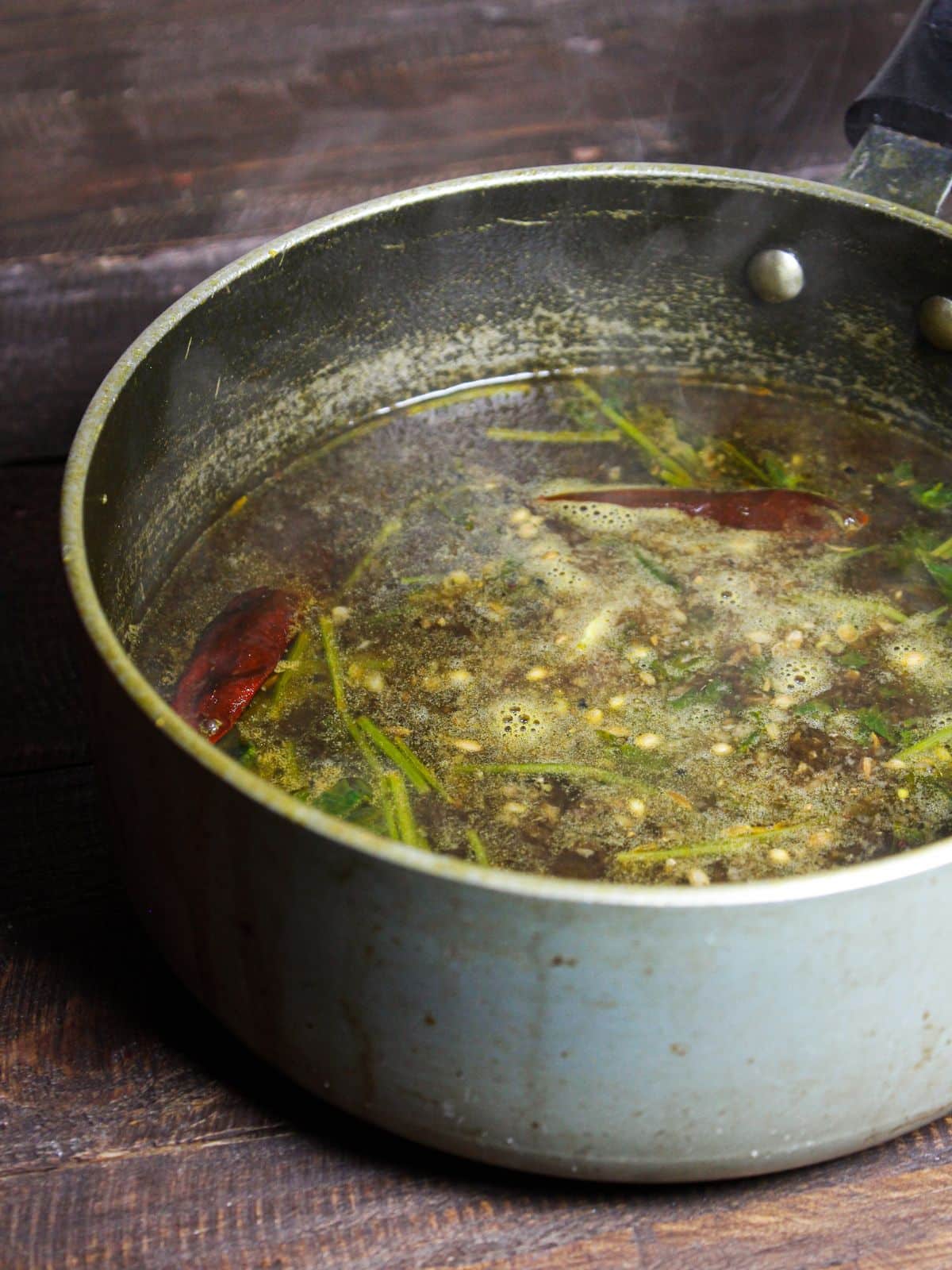 Add the rasam masala paste into the rasam vessel and mix well  