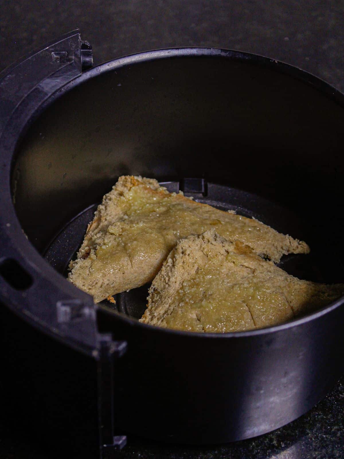 Coat the bread with egg yolk and keep it inside the air fryer and cook properly 