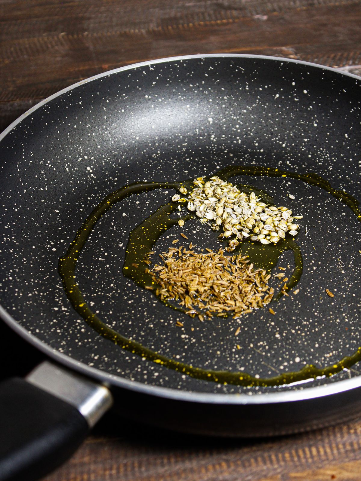 Add cumin and coriander seeds with oil in a pan and saute 