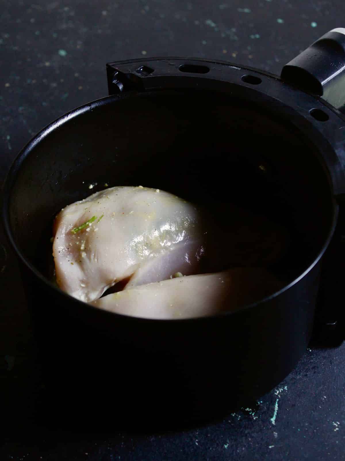 Transfer the chicken pieces into air fryer and fry it 