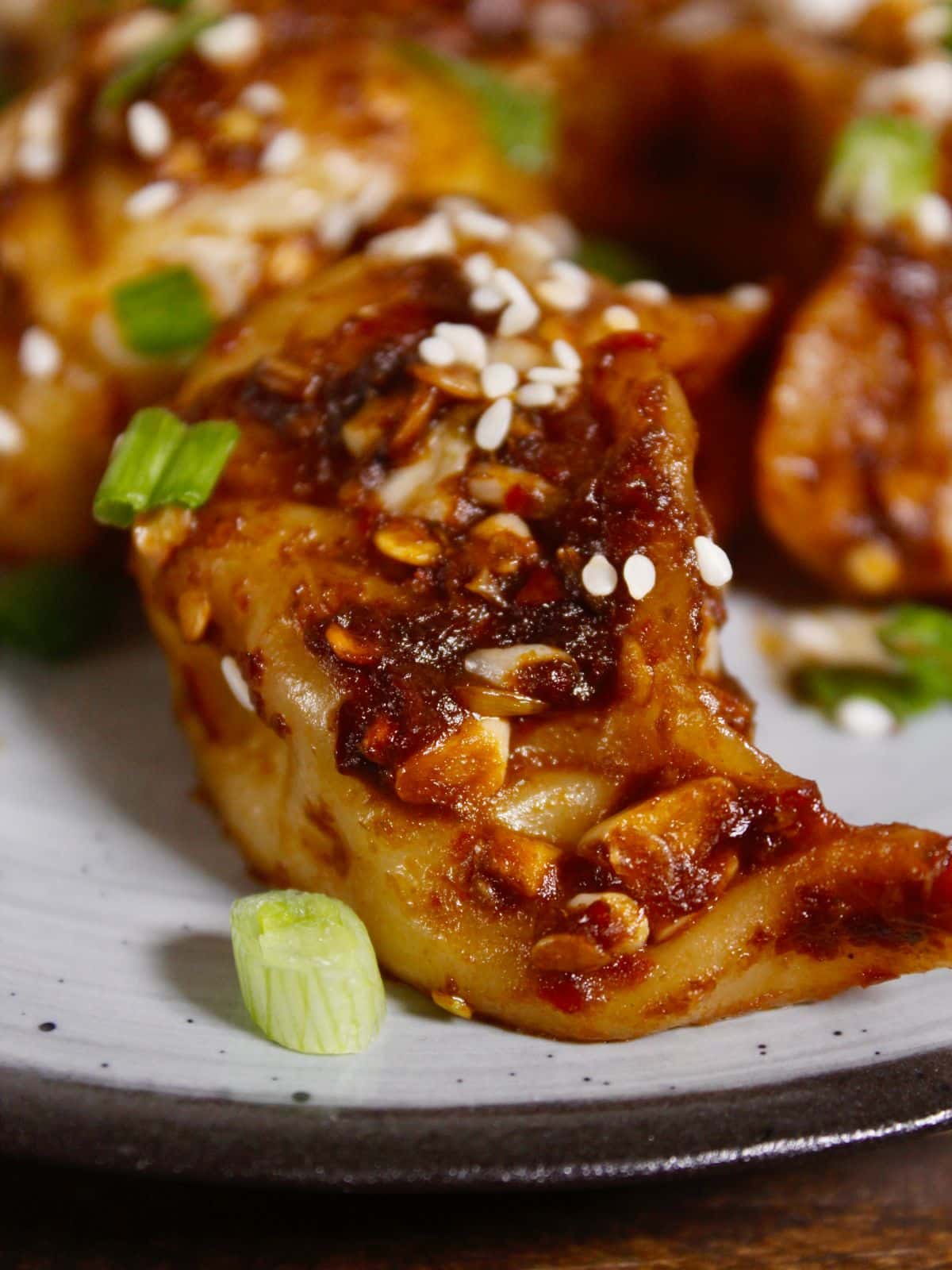 Side view of fried dumpling with spicy sauce