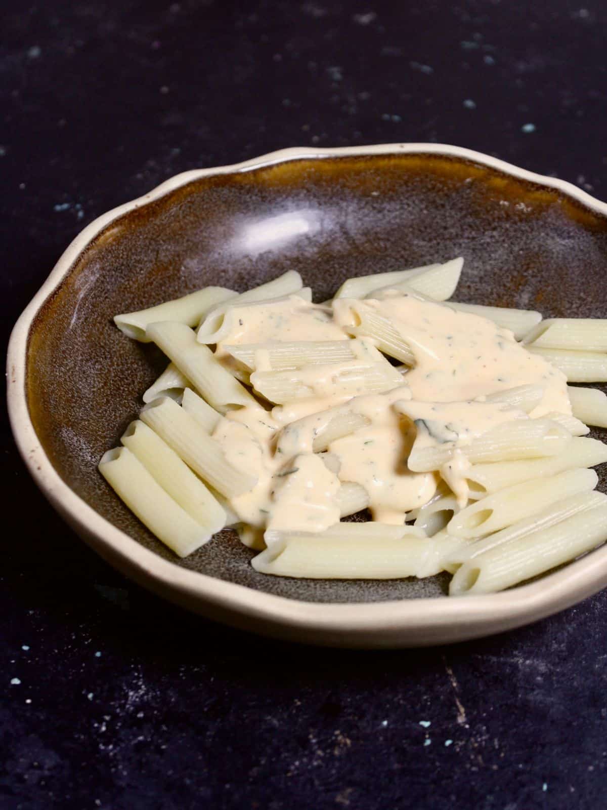 Add boiled pasta with mayo mixture in a bowl
