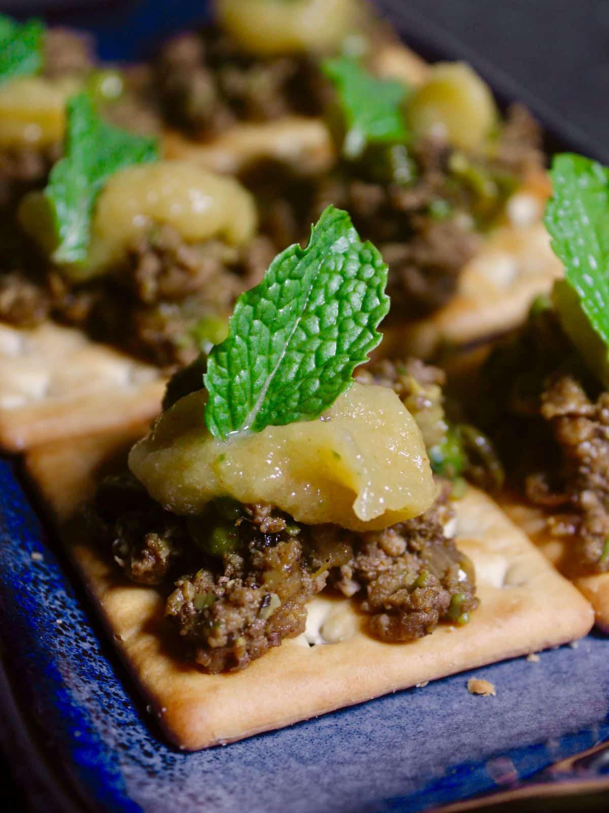 Side view of Minced Lamb Canapes with Spicy Tangy Dressing