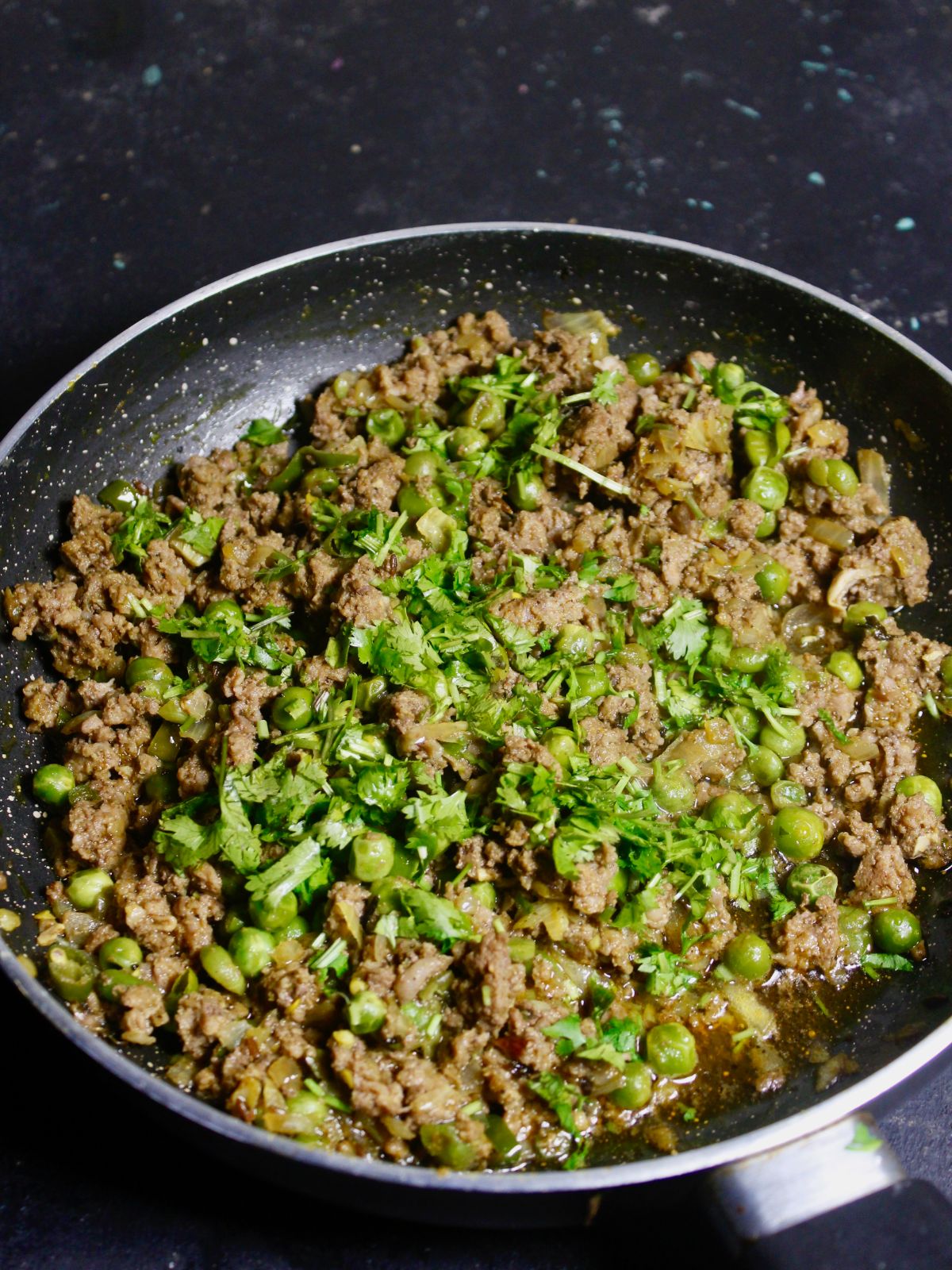 Add minced lamb, sprinkle coriander leaves and mix well until its golden in color 
