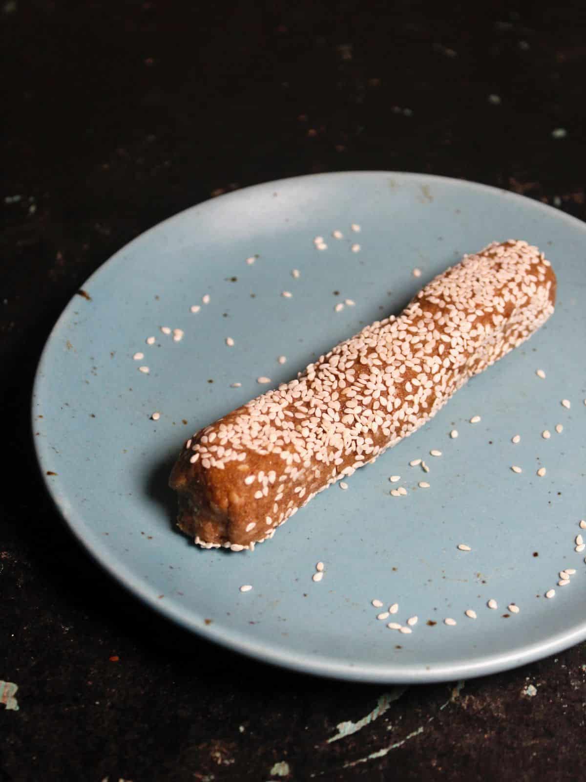 Roll the mixture over sesame seeds 