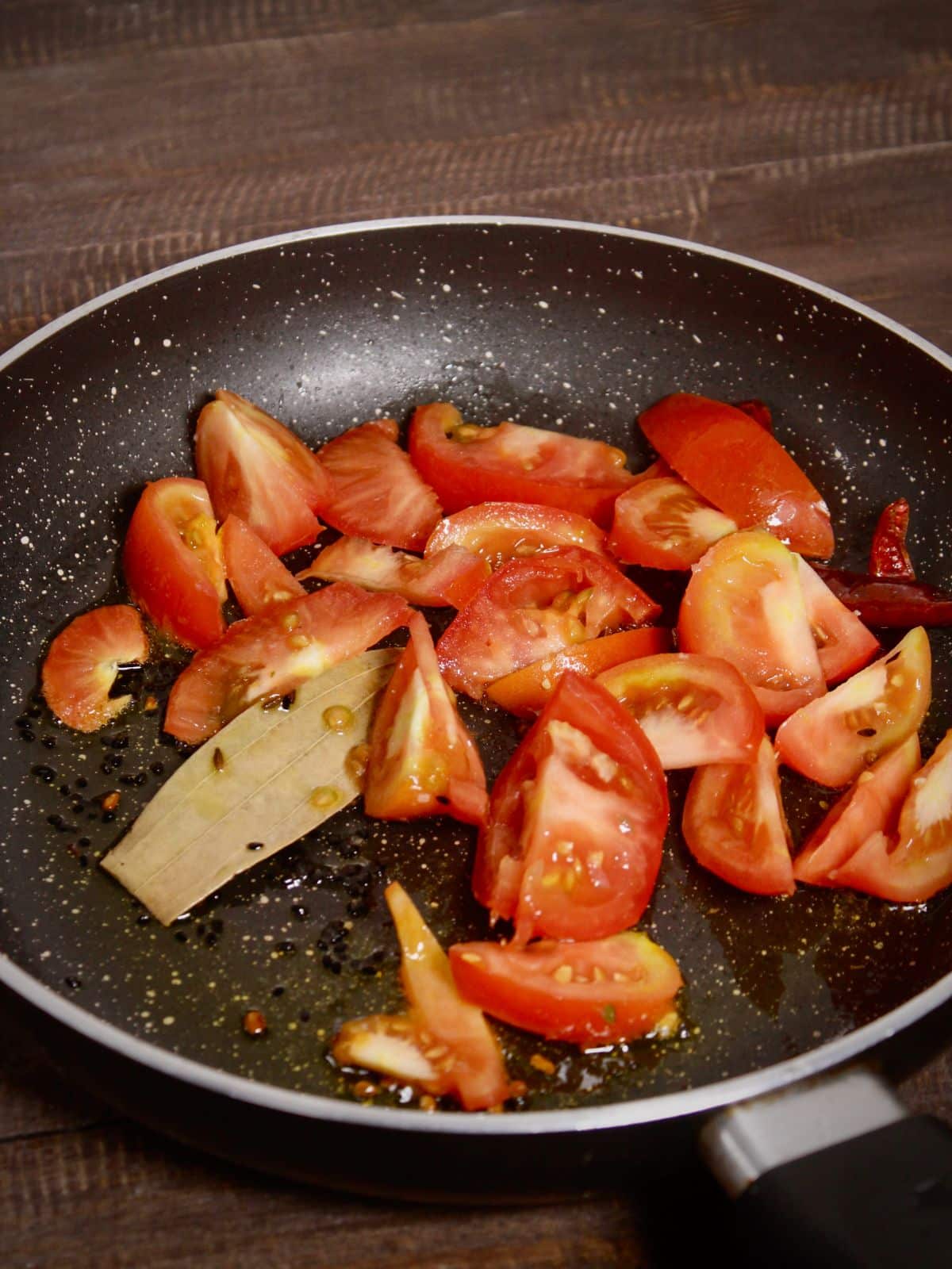 add chopped tomatoes to the pan 