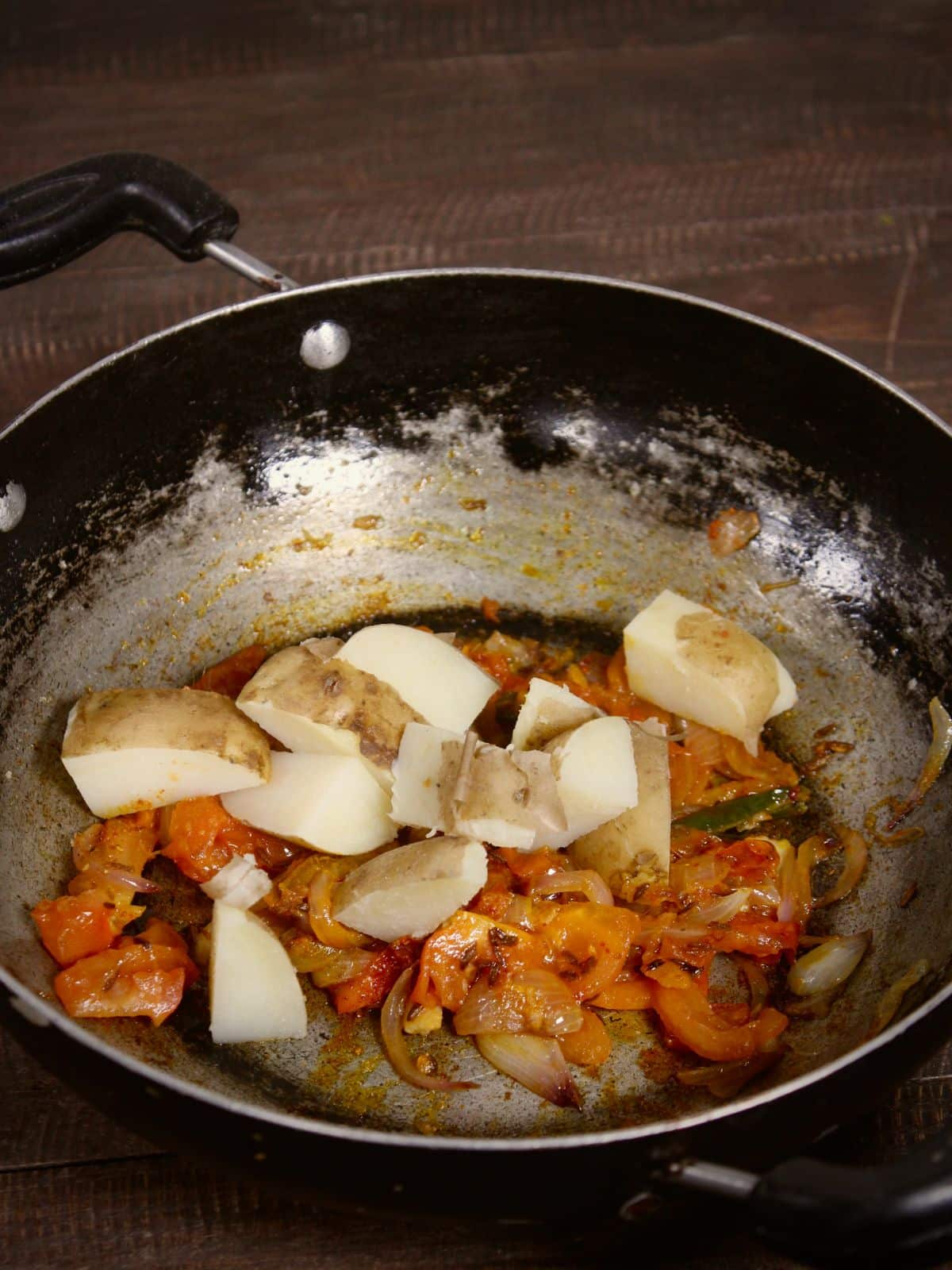 add chopped boiled potatoes to the pan and mix well