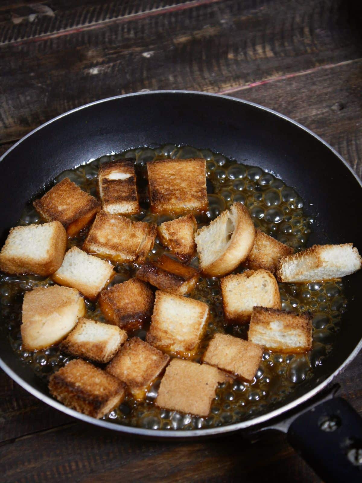 add roasted bread cubes into the pan and mix well
