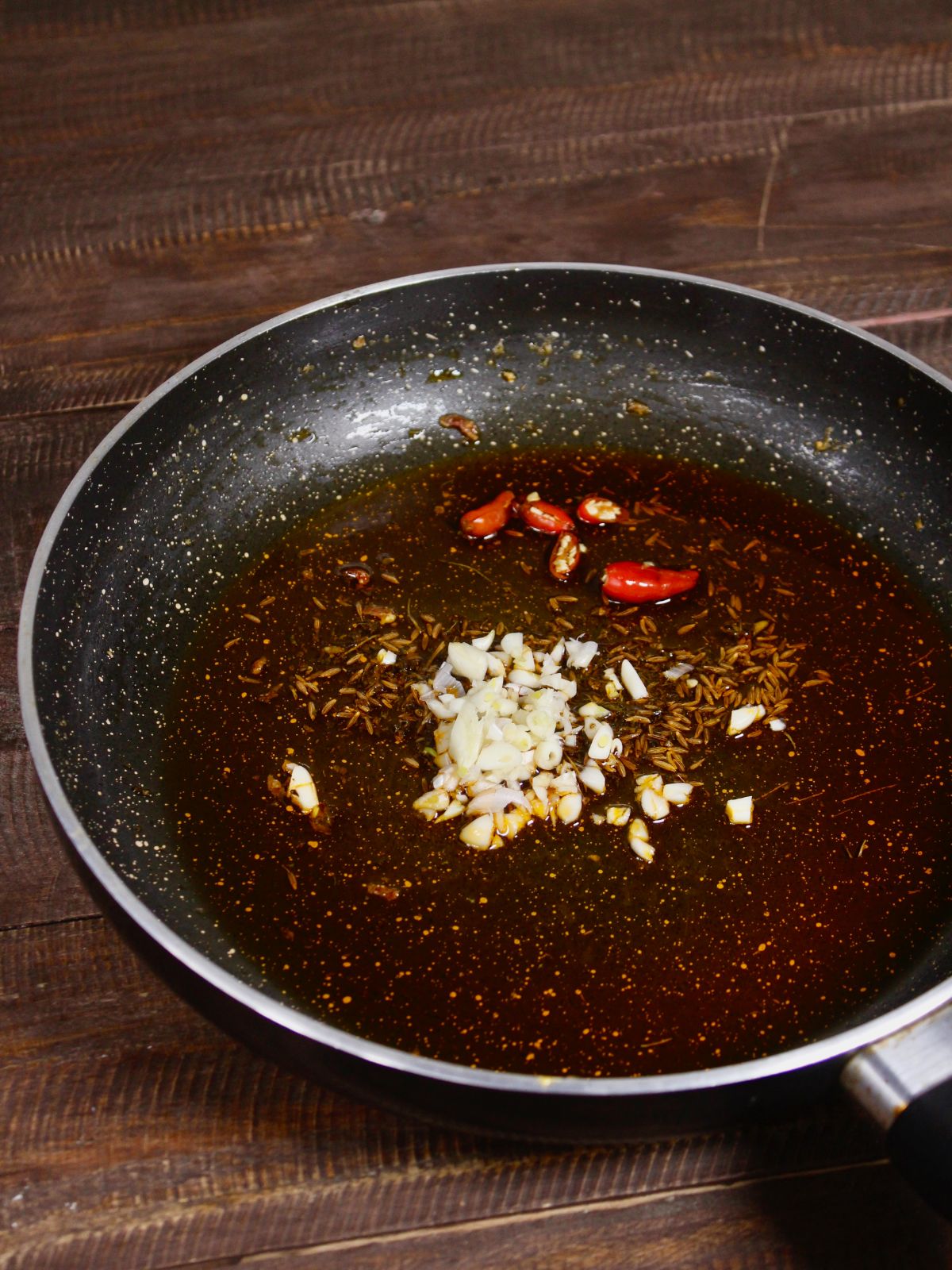 add chilies, garlic to the pan and saute 