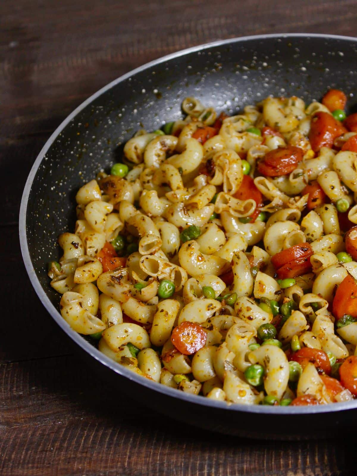 half pan view of carrot and peas macaroni