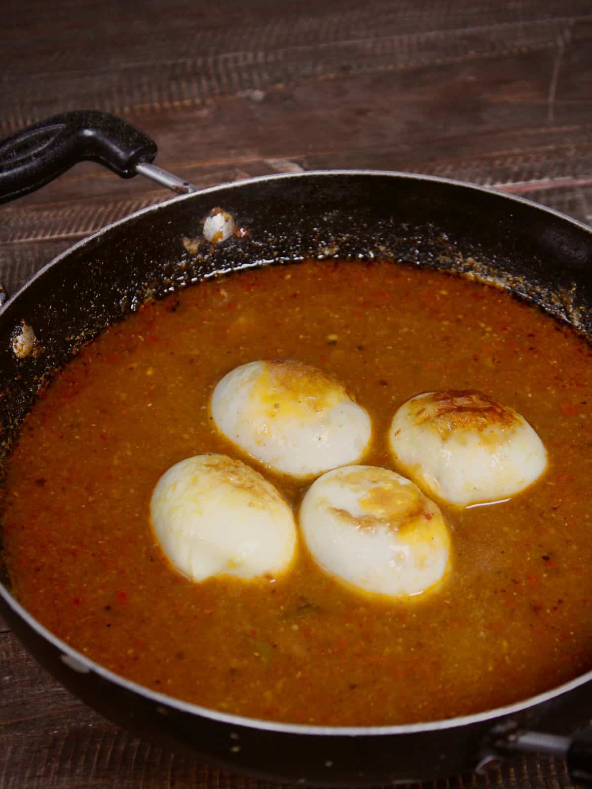 Add boiled eggs into the mixture and cook well