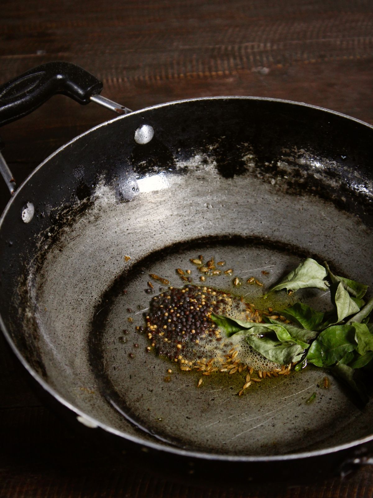 add cumin seeds, mustard seeds and curry leaves in a pan and saute 