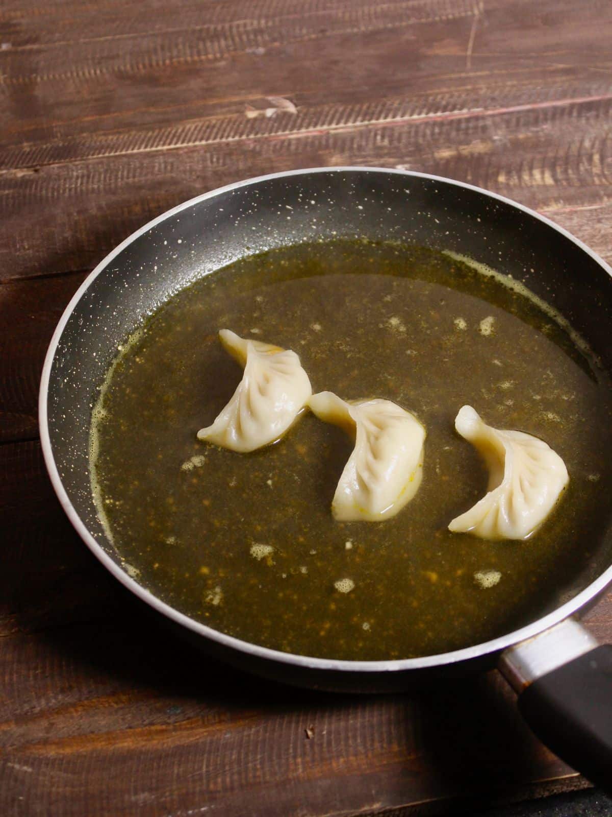 Dumplings added to the liquid in pan and cook 