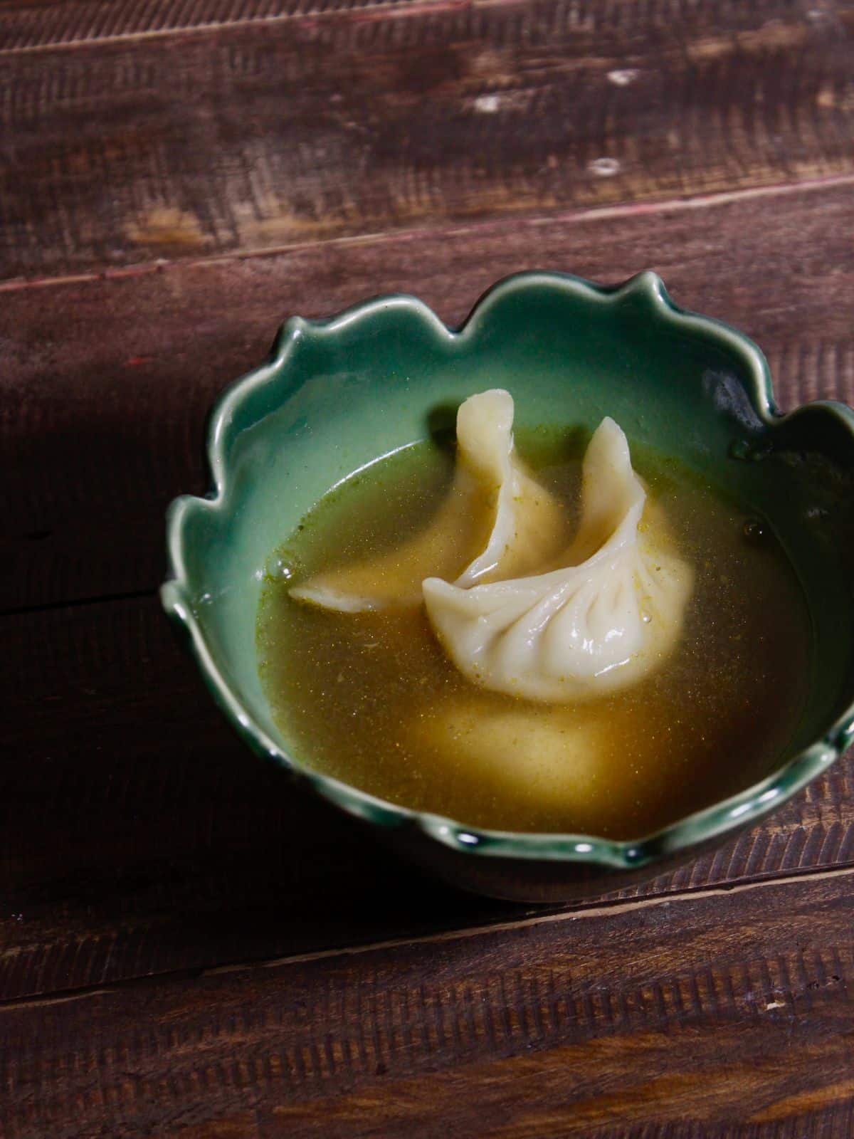 dumplings with broth transferred in a bowl 