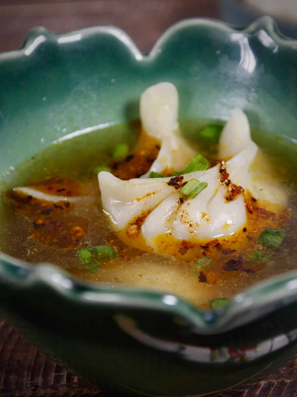 Side view of dumplings with warm broth