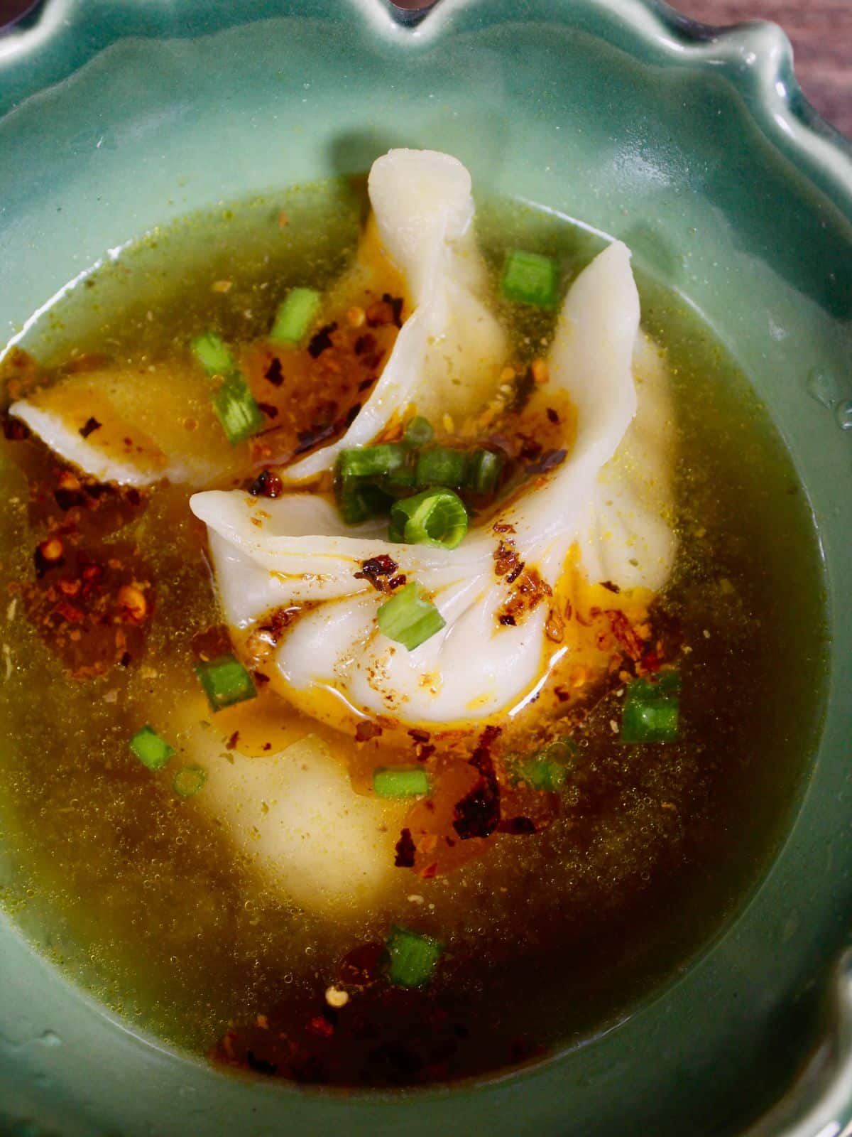 Super Zoom top view image of dumplings with warm broth