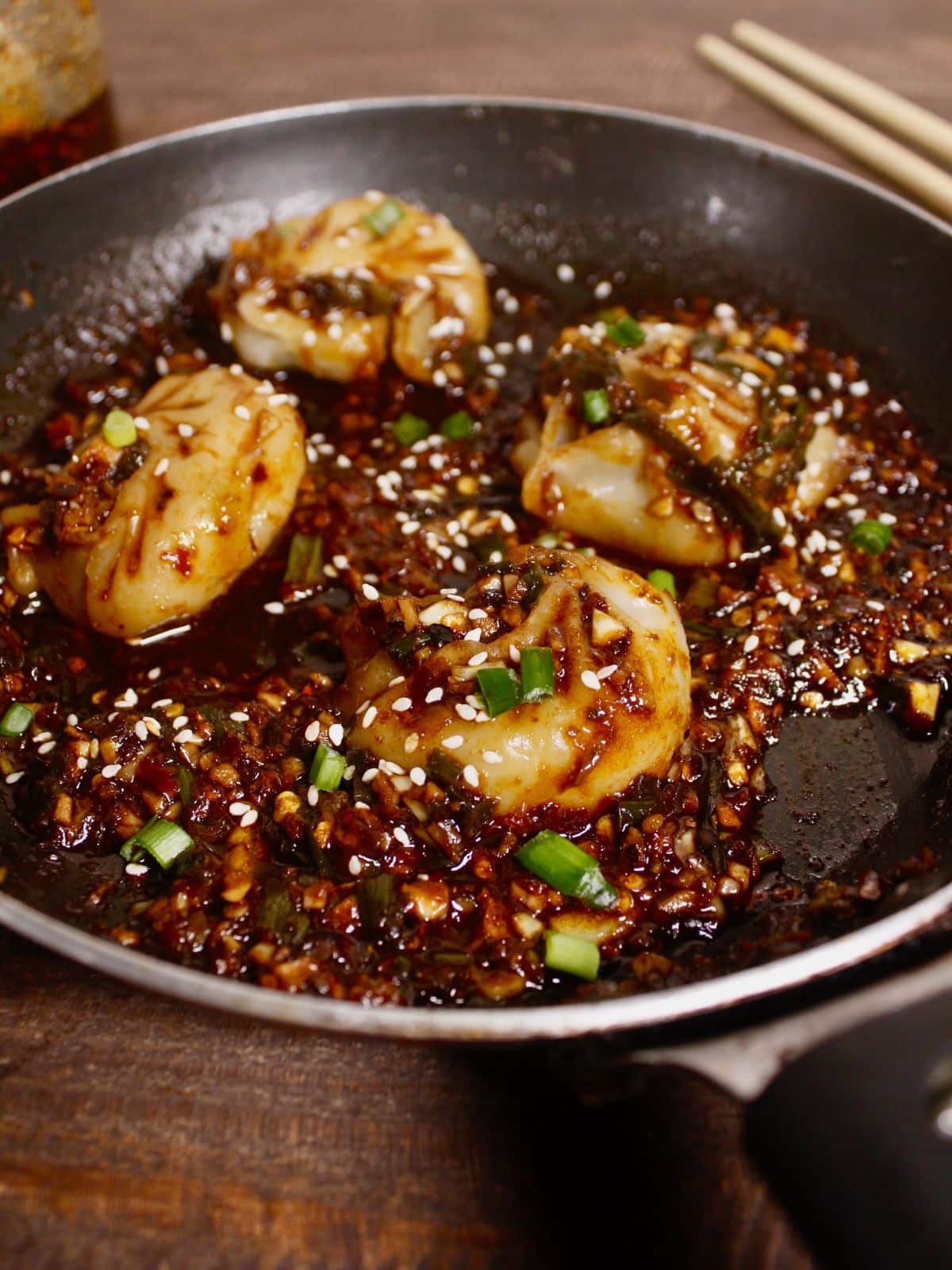 side view of dumplings with hot garlic sauce