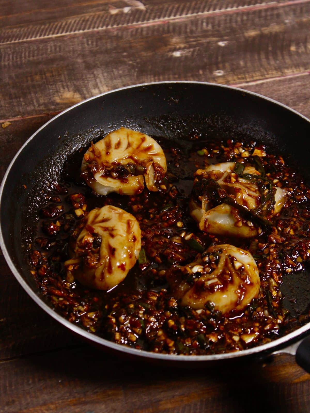 add steamed dumplings into the mixture and coat well 