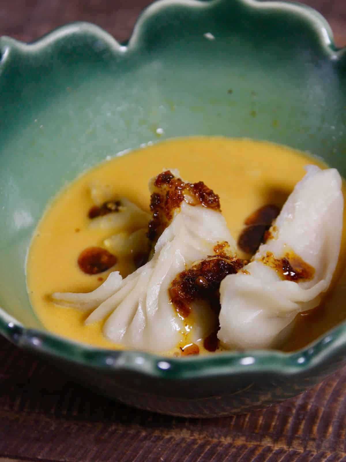 garnish dumplings in peanut sauce with some chili oil and enjoy 
