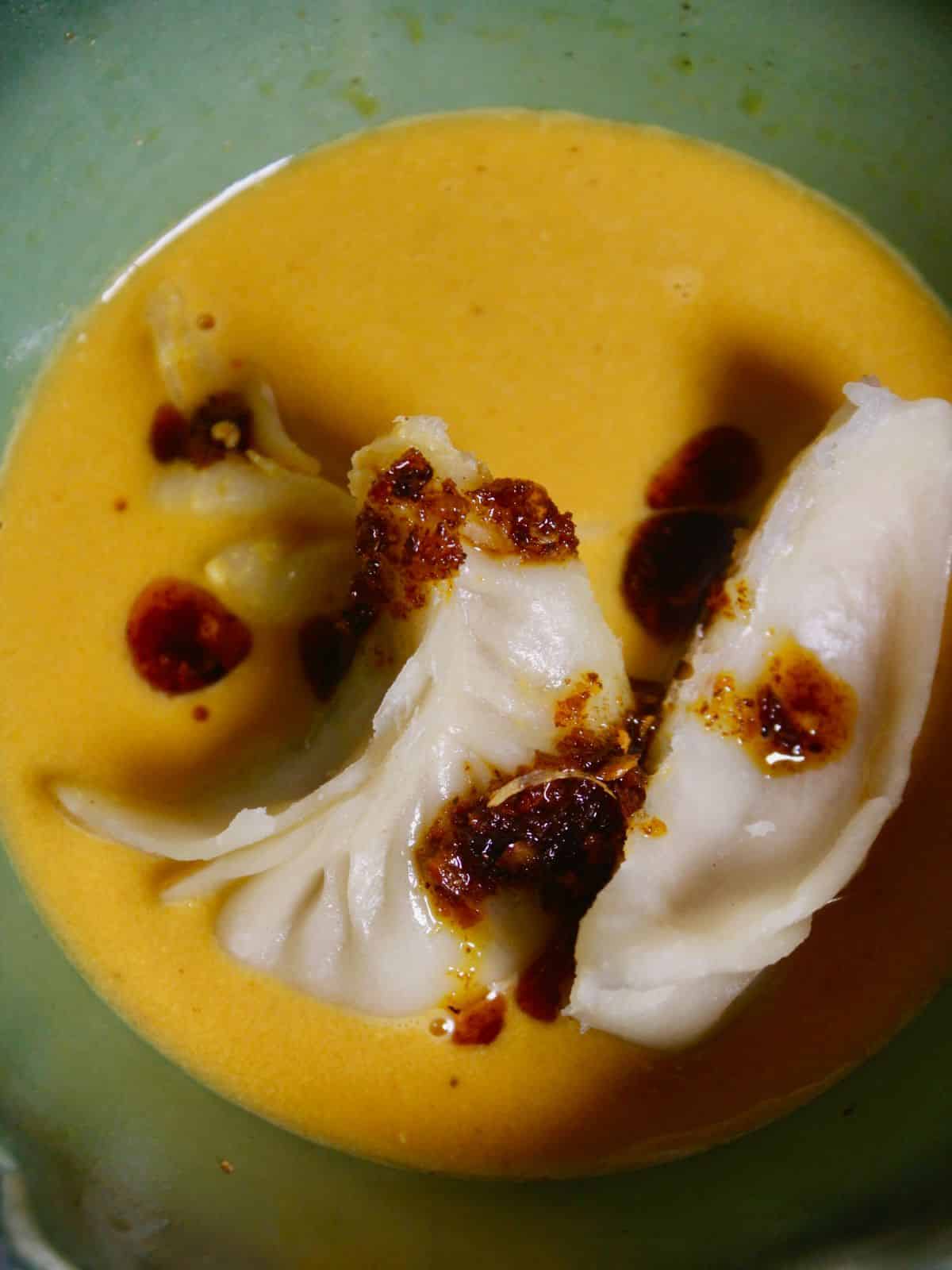 Top view image of dumplings in peanut sauce