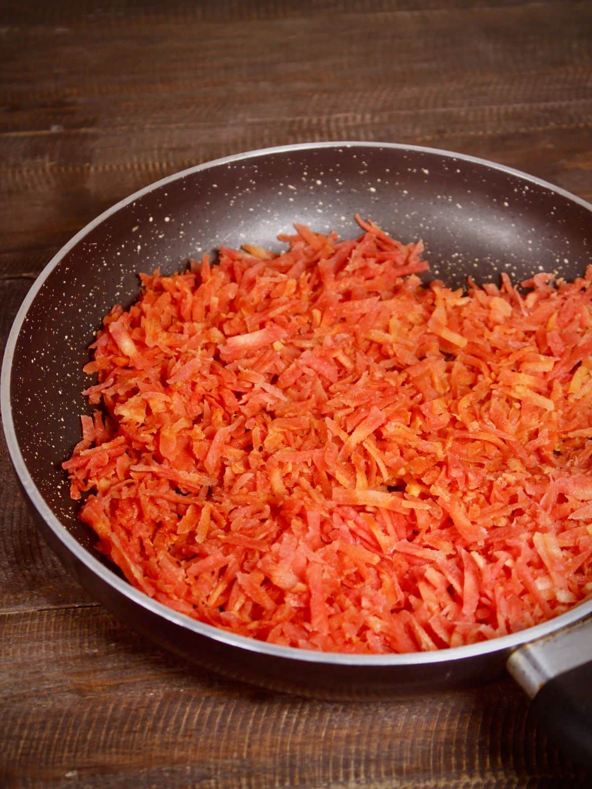 grated carrots in a pan 