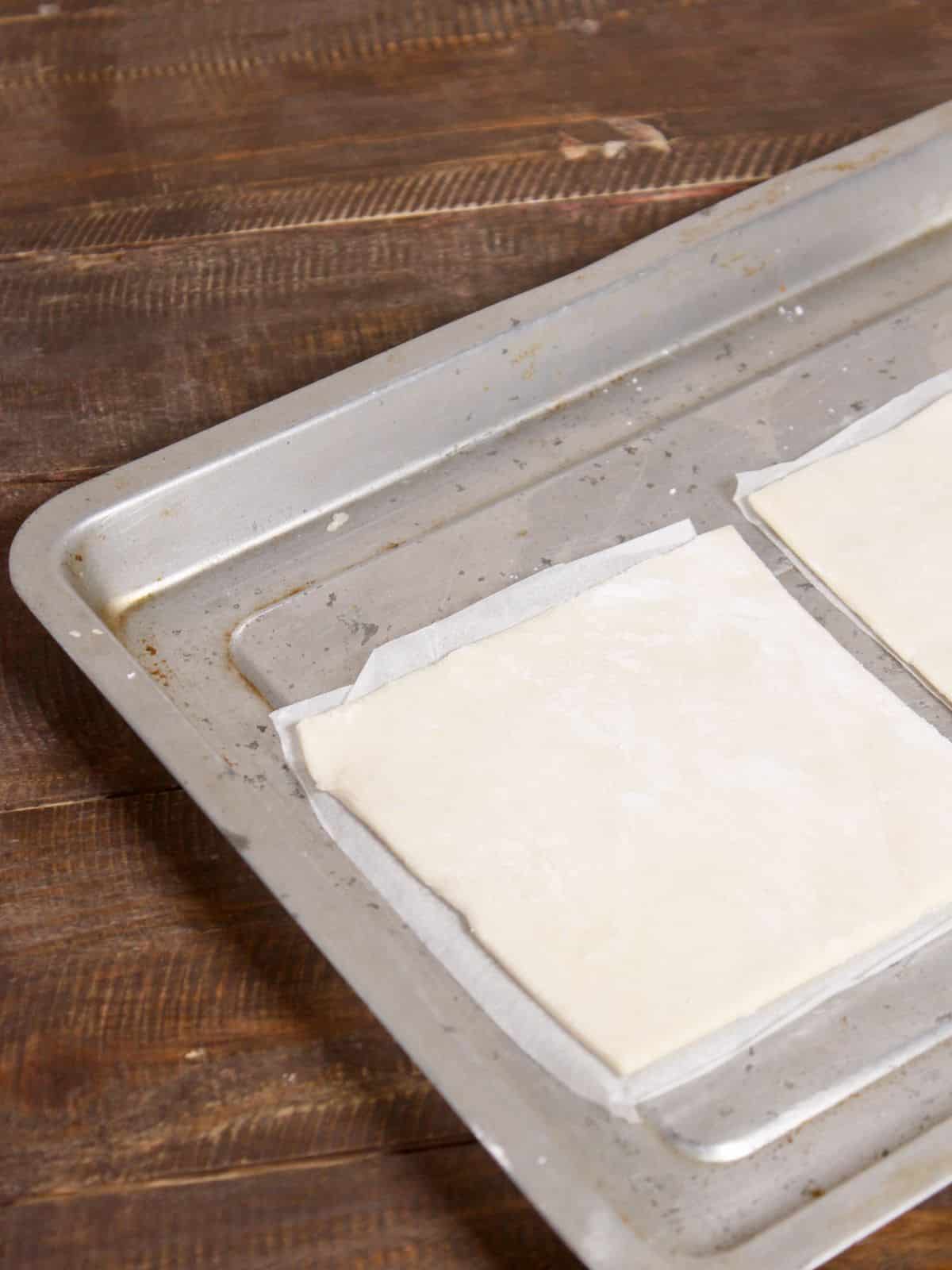 take pastry puff sheet in a baking tray 