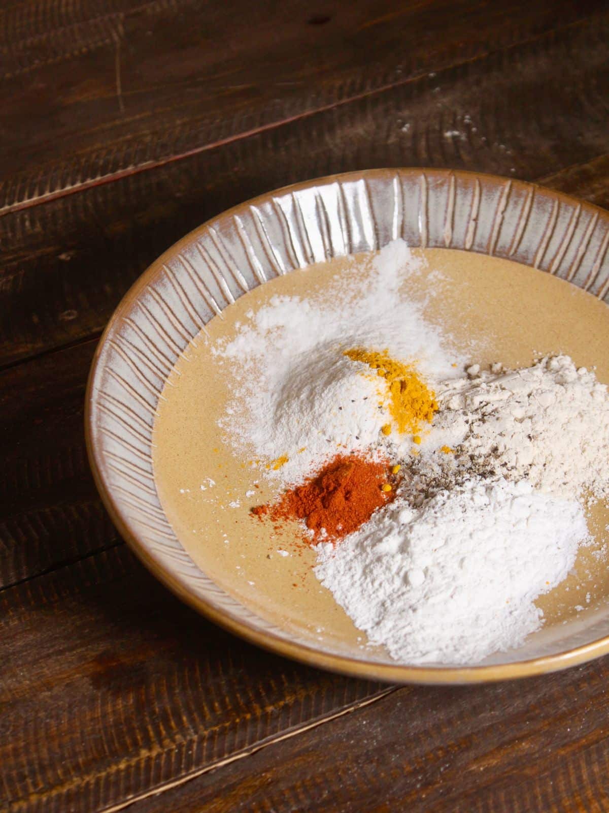 add powdered spices to the flour and mix well