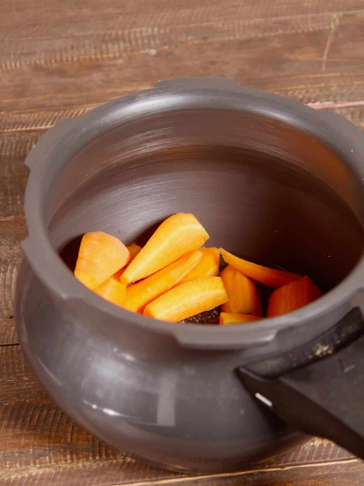 add chopped carrots to the cooker 