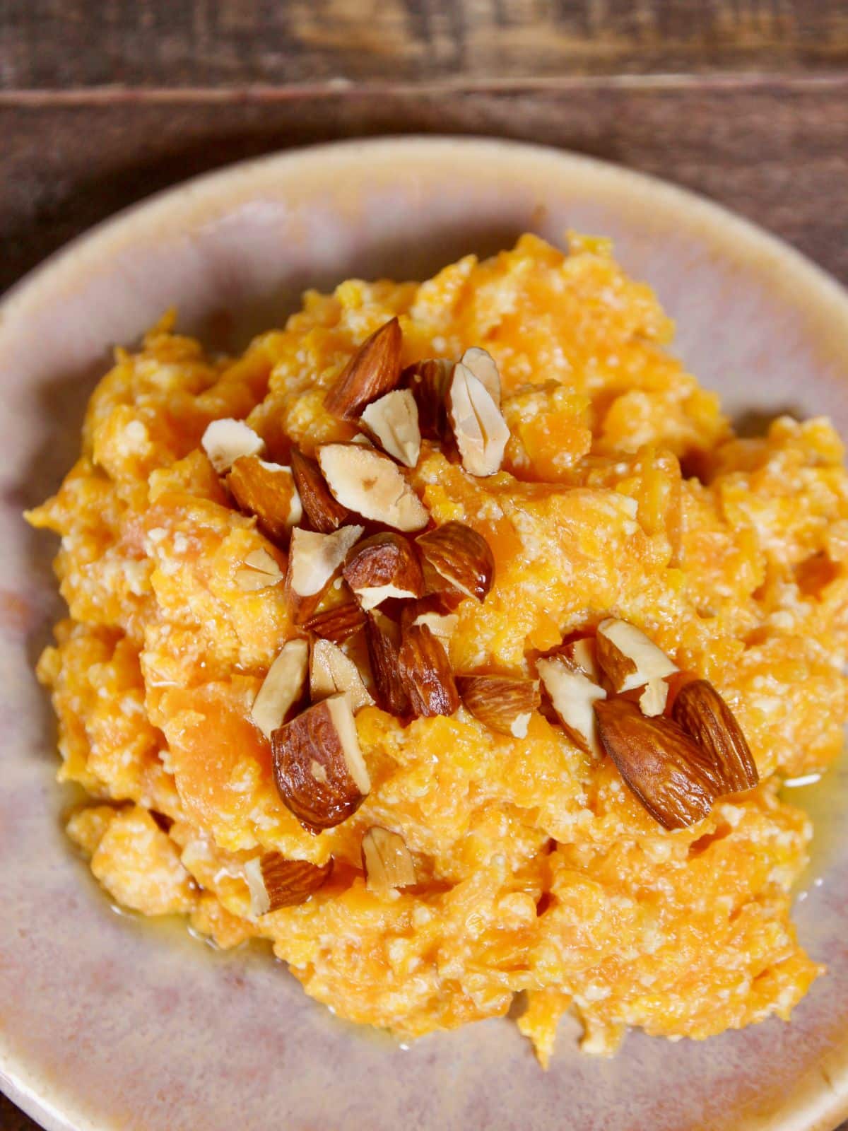 garnish pressure cooker gajar ka halwa with fried chopped almonds and enjoy 