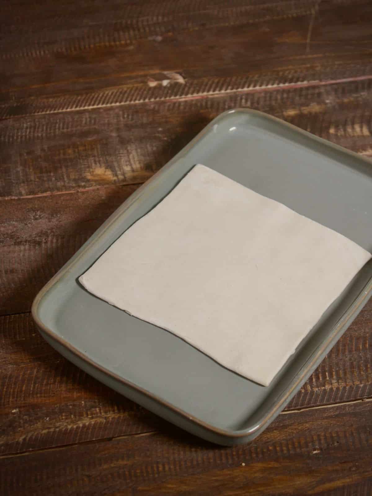 square shaped pastry sheet on a tray 