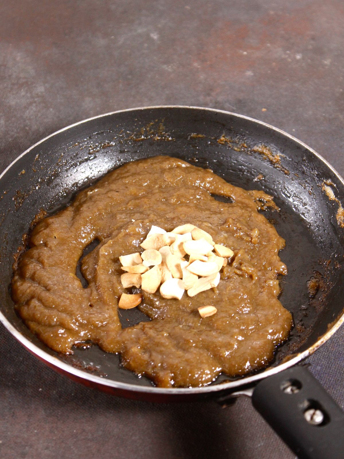 add some roasted cashews to the mixture and cook 