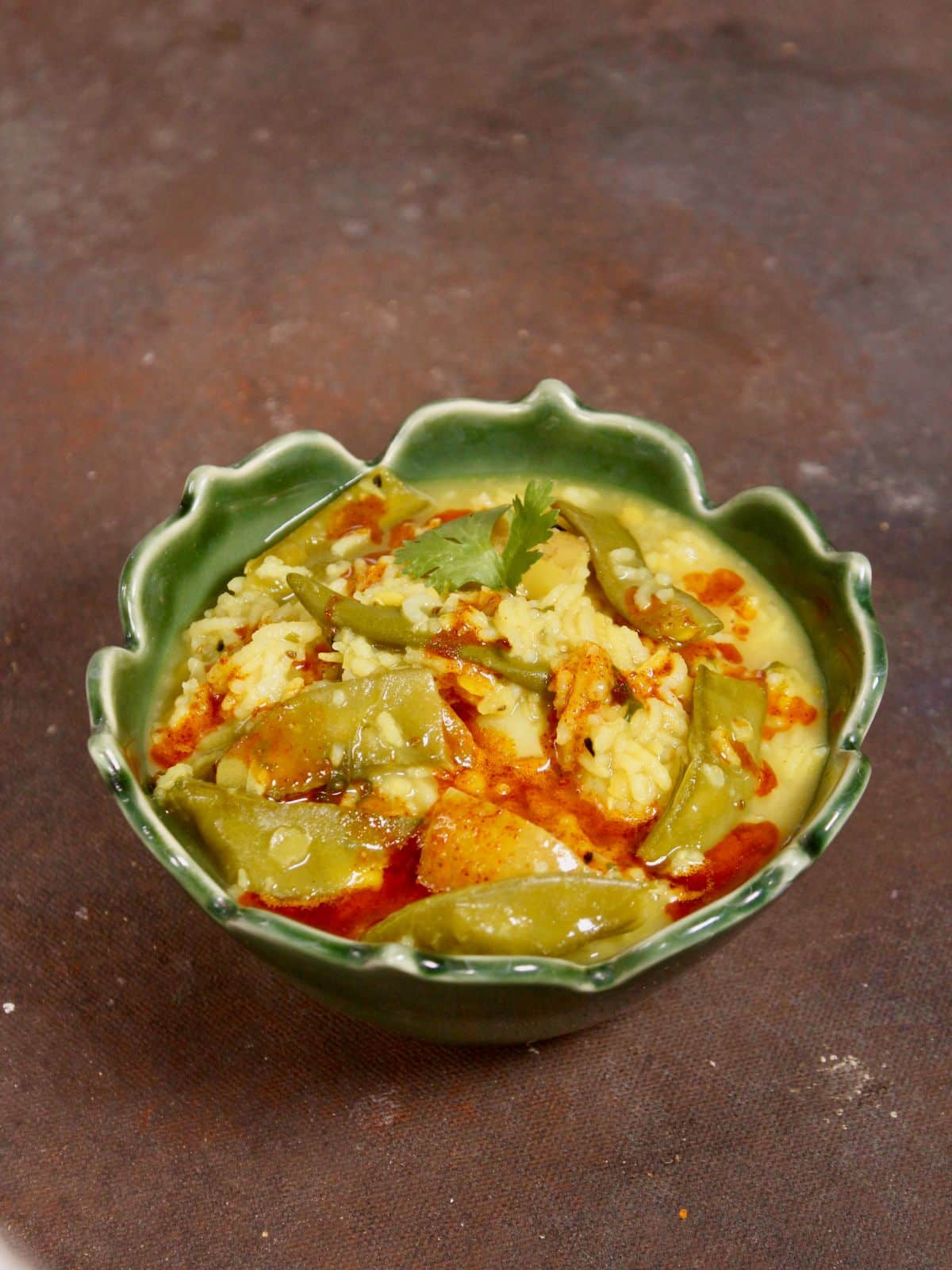 garnish the khichdi with red chili oil and serve hot 