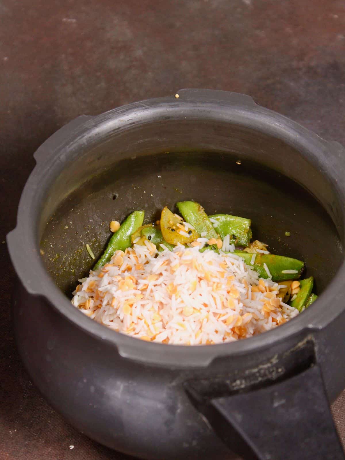 add soaked rice and red lentils to the pressure cooker 