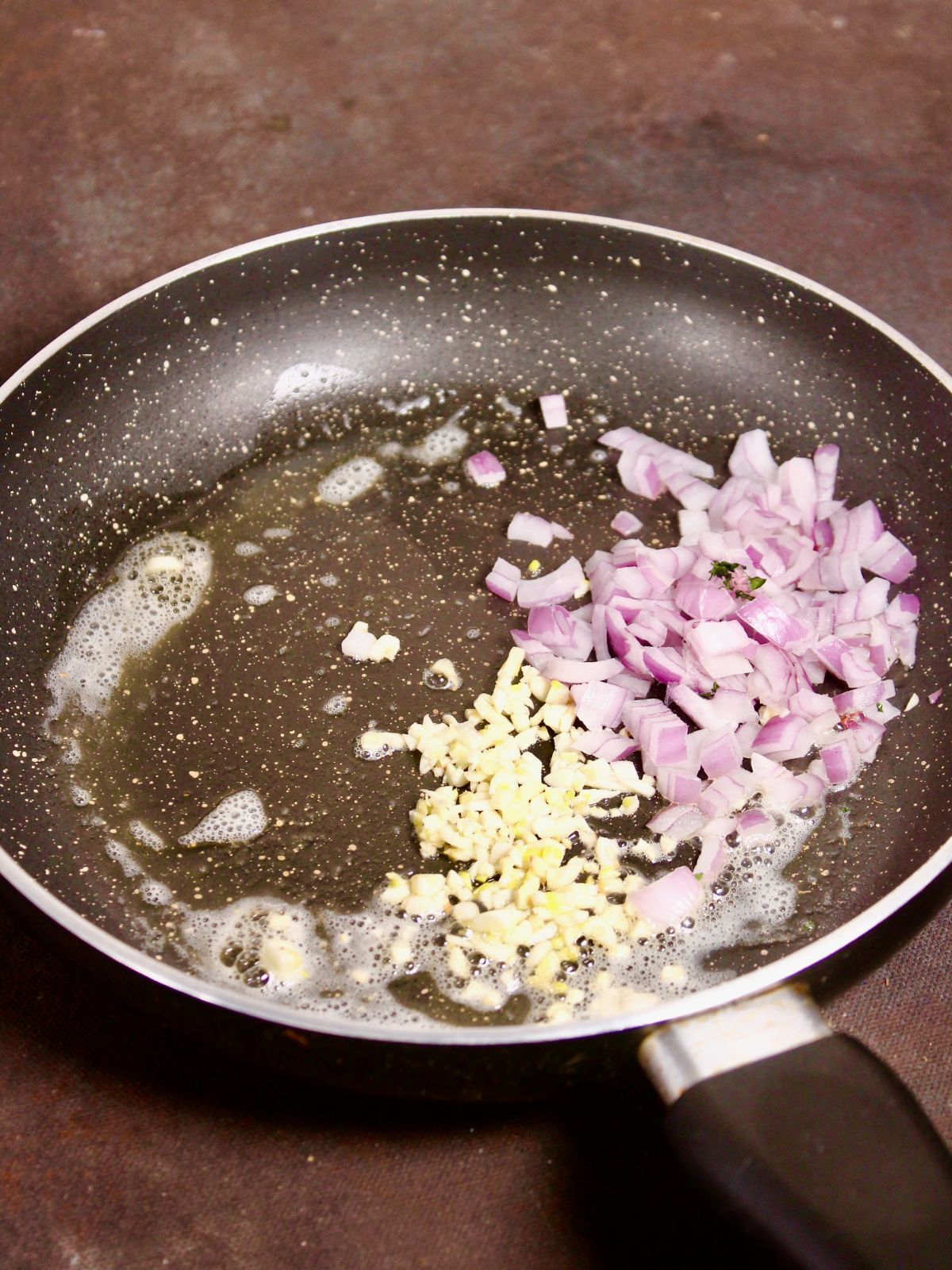 add chopped onions with garlic and butter in a pan 