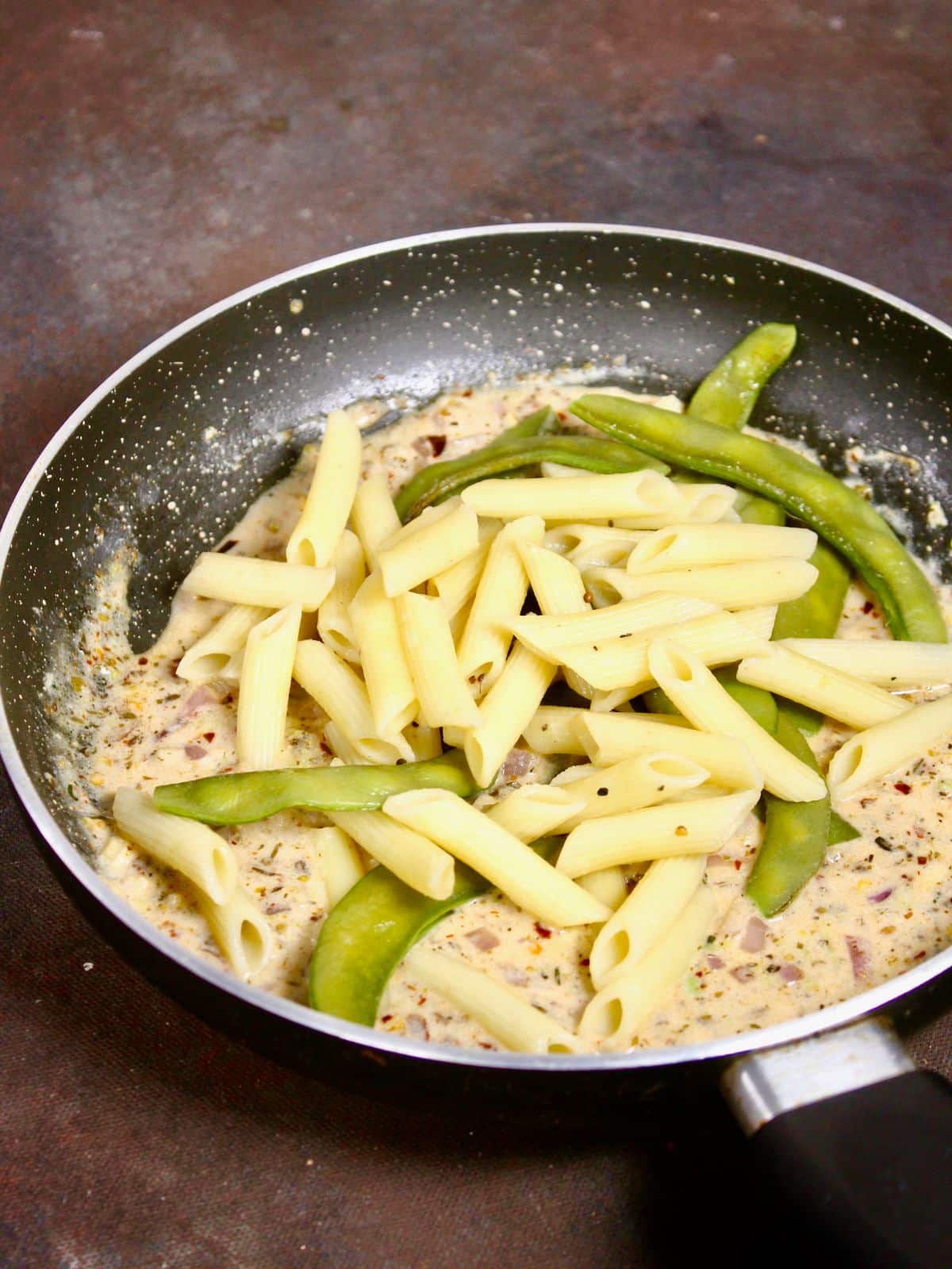 add boiled pasta and beans into the sauce and mix well 