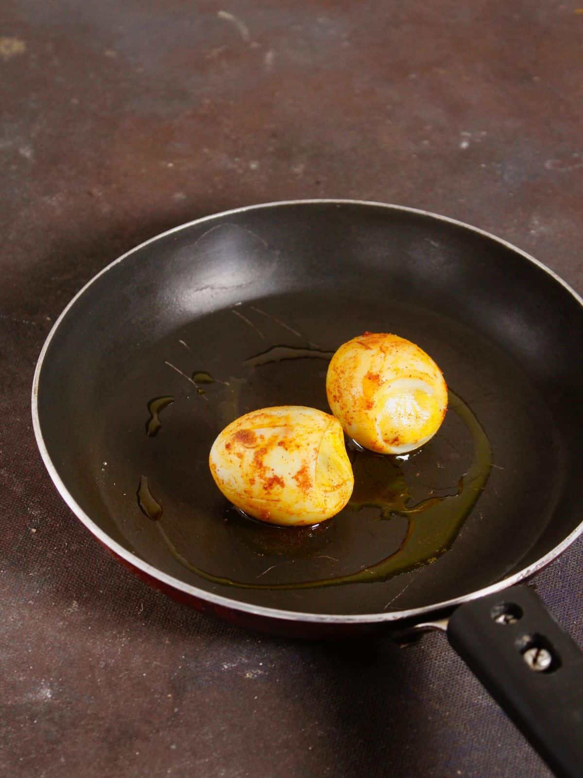 saute the coated eggs on a pan 