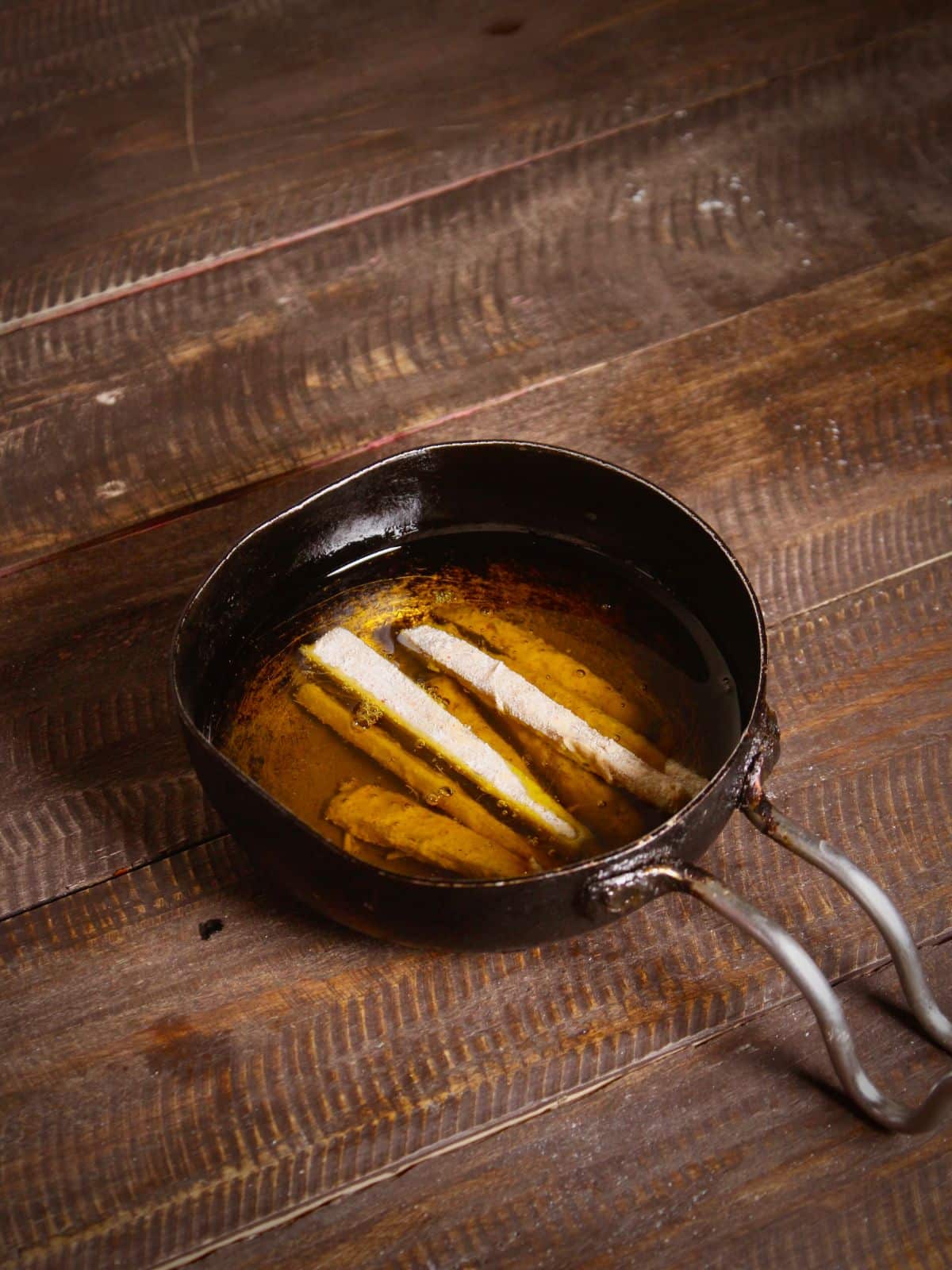 fry coated banana stems into the oil 