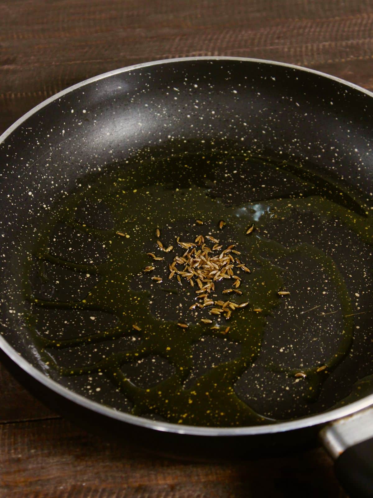 add cumin seeds with oil in a pan 
