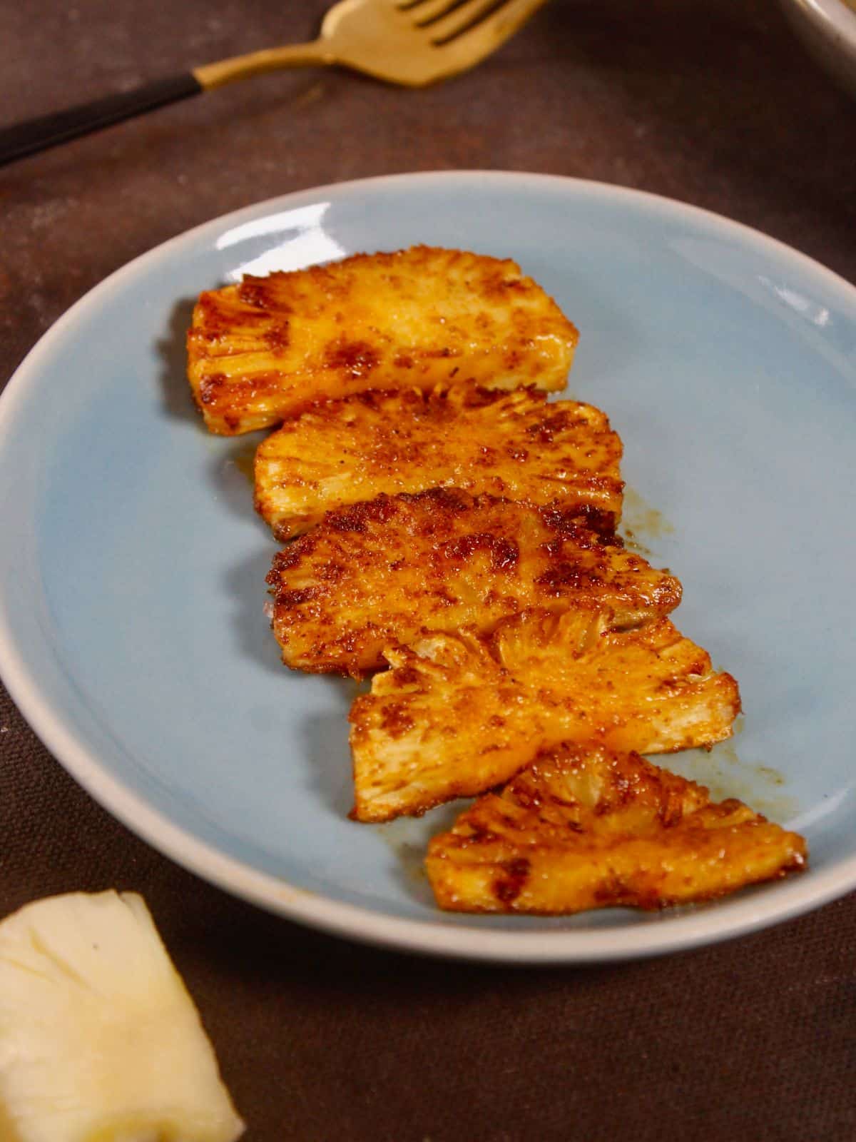 grilled pineapple lined up on a plate